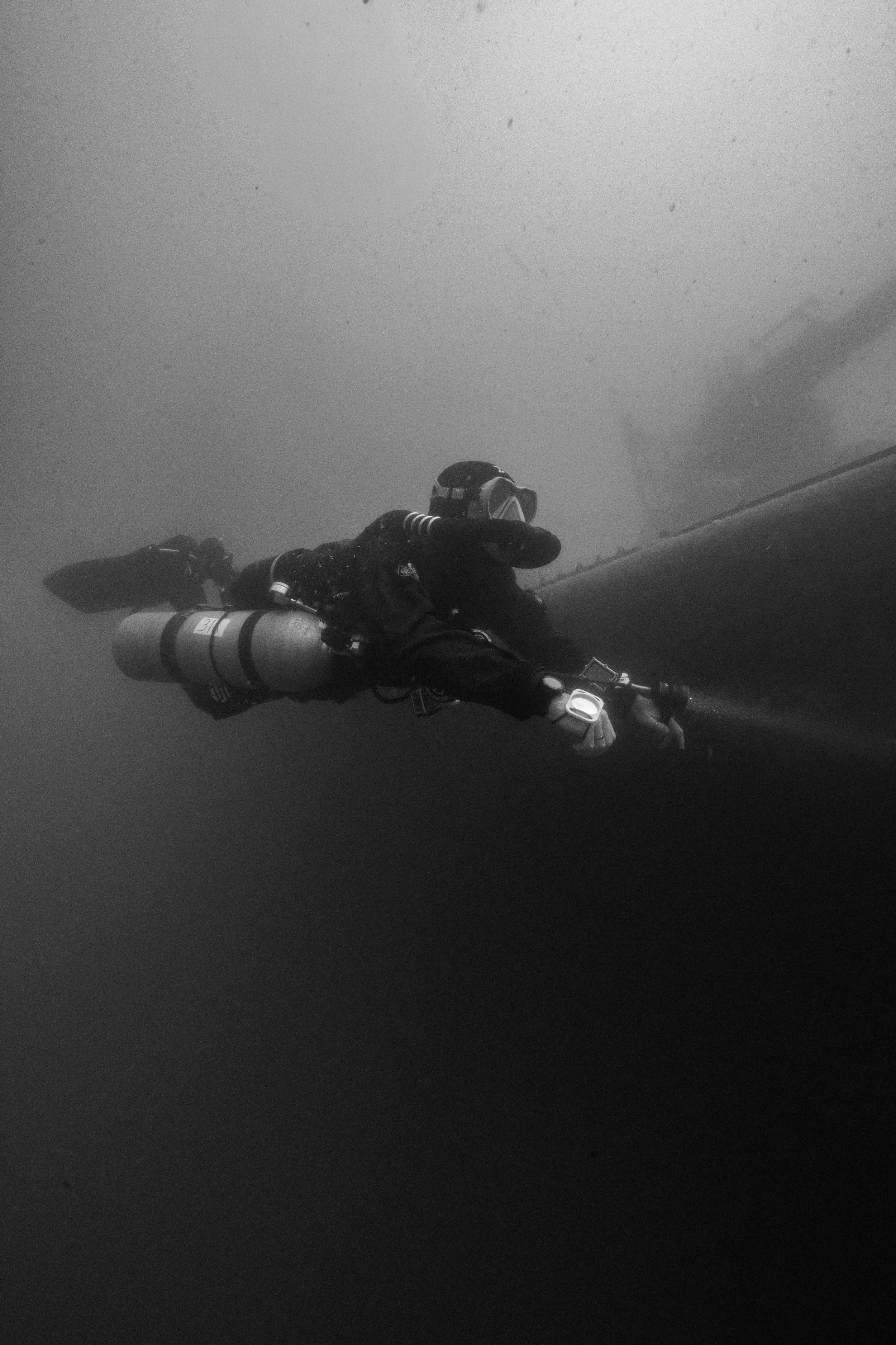 Black and white picture of a rebreather diver on sa shipwreck