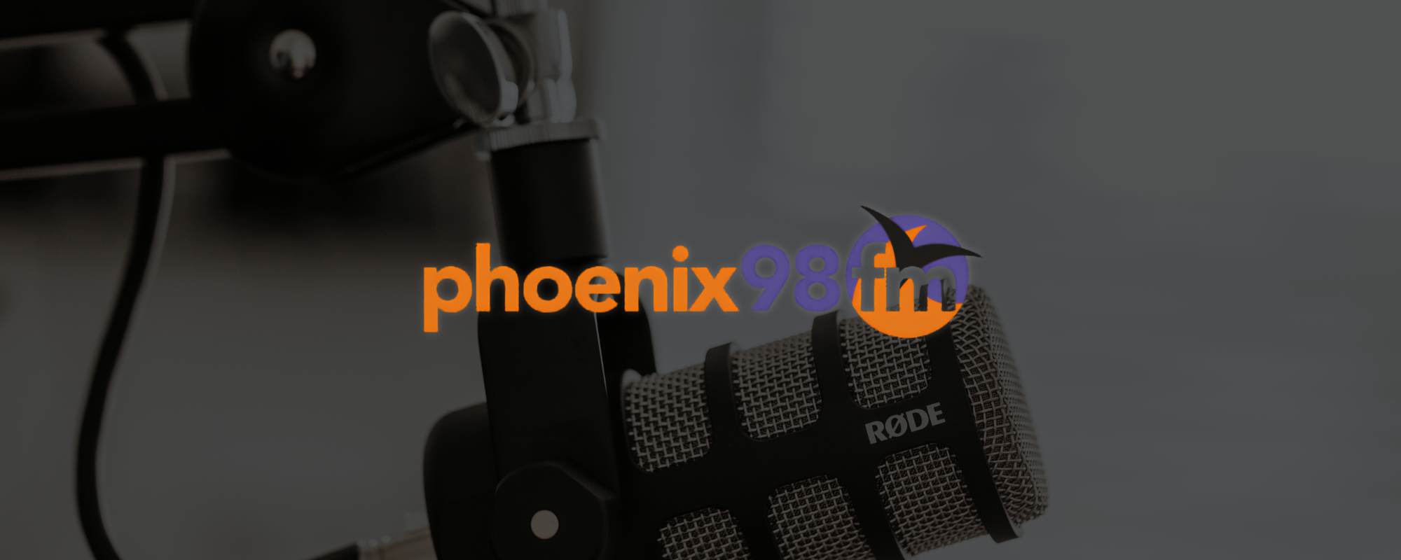 Microphone in radio studio with Phenix FM logo, representing Sunrise Technologies supporting a Brentwood community radio station