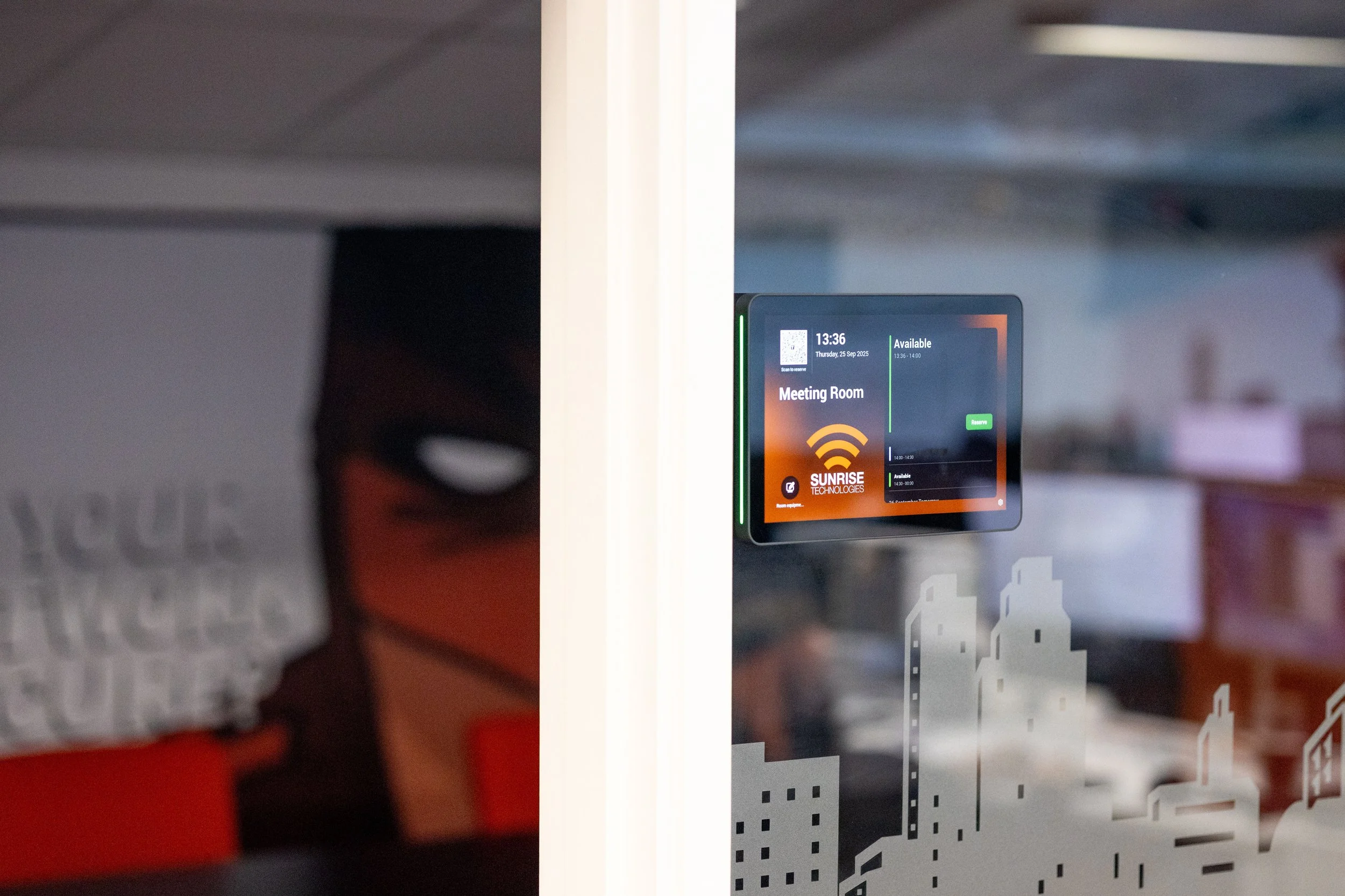 Digital meeting room booking display outside an office meeting space