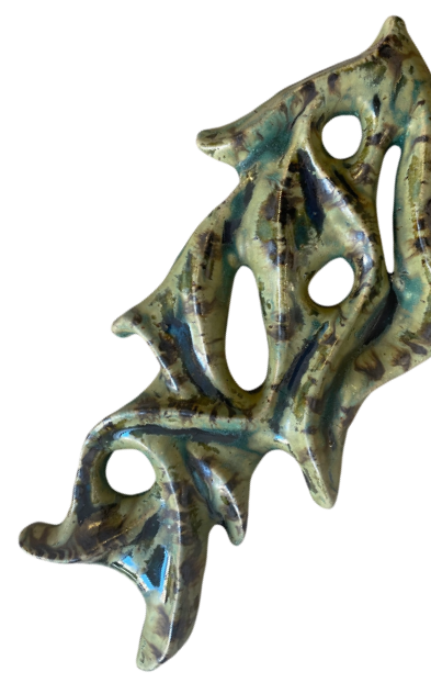 Abstract ceramic wall hanging in green glaze