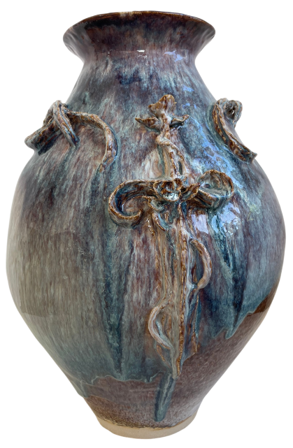 Stoneware vase made in ceramics by an artist with drippy blue glaze and a sword design on the front
