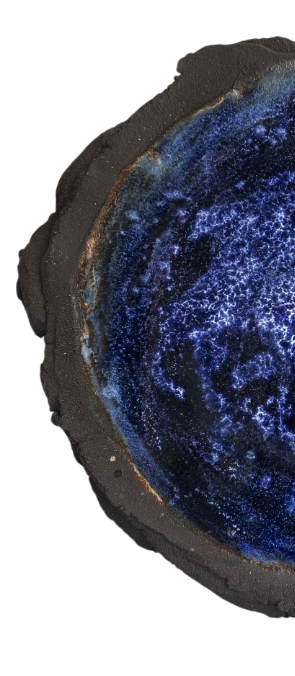 Cross-section of a geode with a dark gray outer layer and vibrant blue crystalline interior.