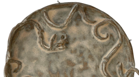Handmade beige stoneware plate with sirlws and snakes