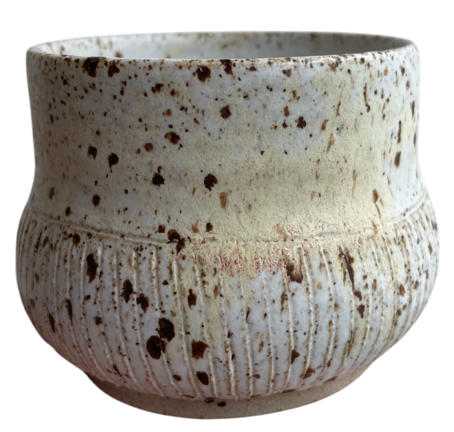 spotted ceramic mug without a handle