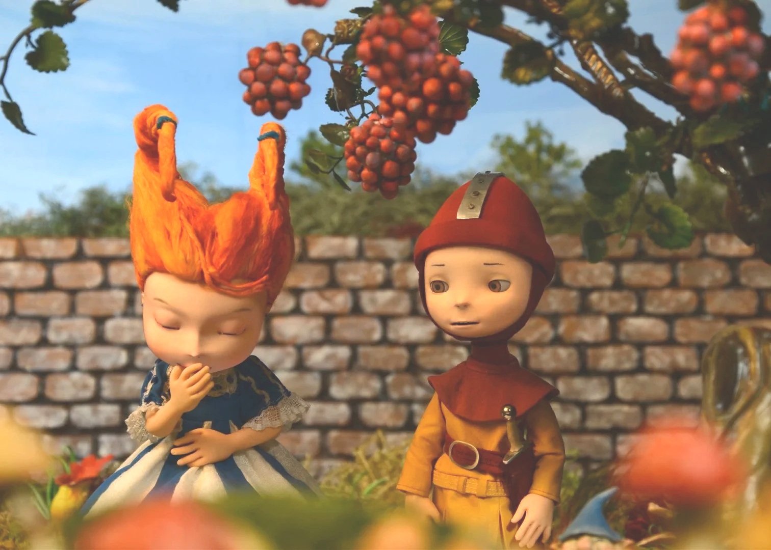 Stop-motion characters from “Dangerously Ever After” standing outdoors beneath berry branches, promoting the short film adaptation.