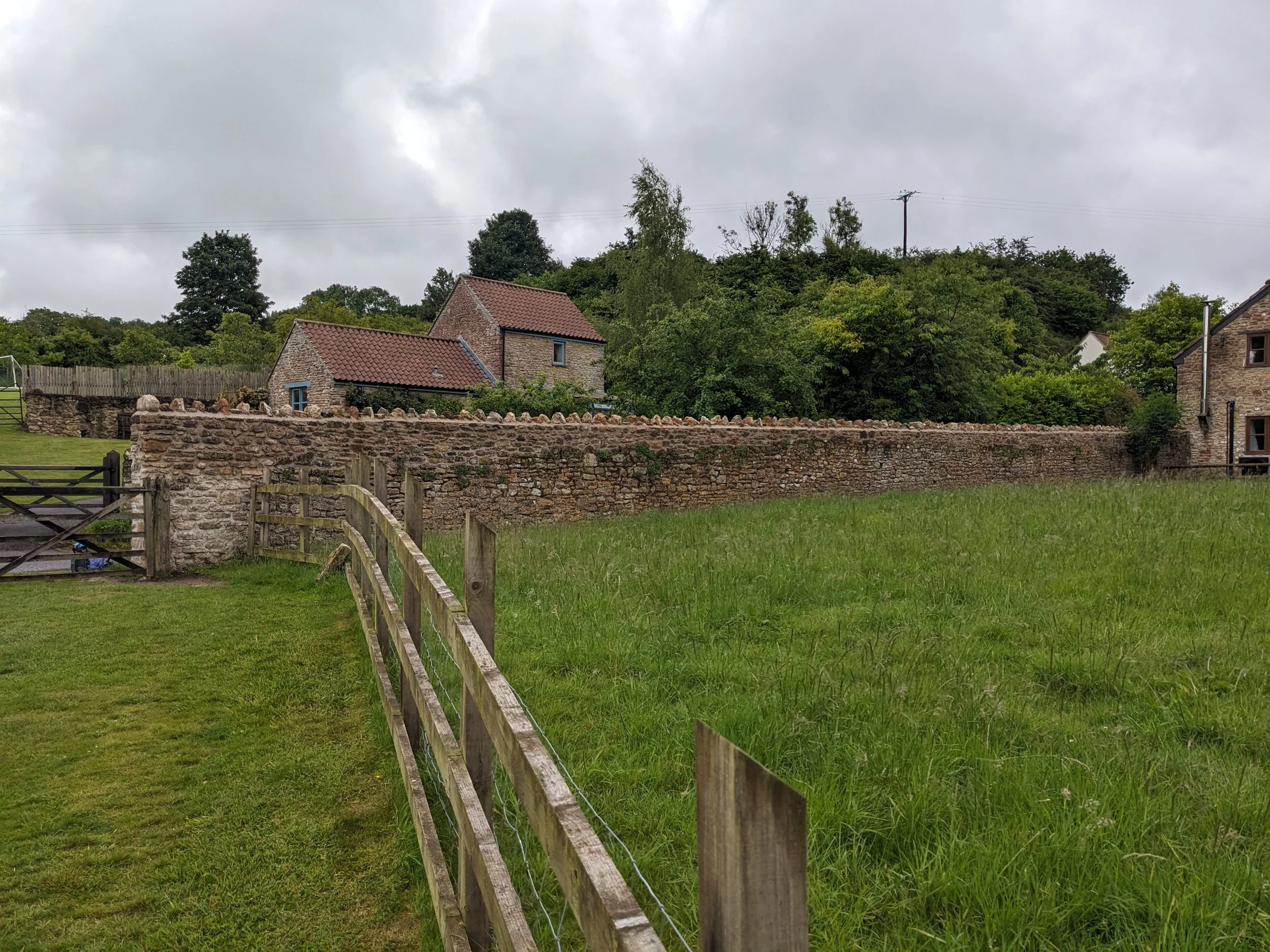 A Lime mortared stone wall in Winscombe, Somerset. A rural Scene with a countryside cottage.