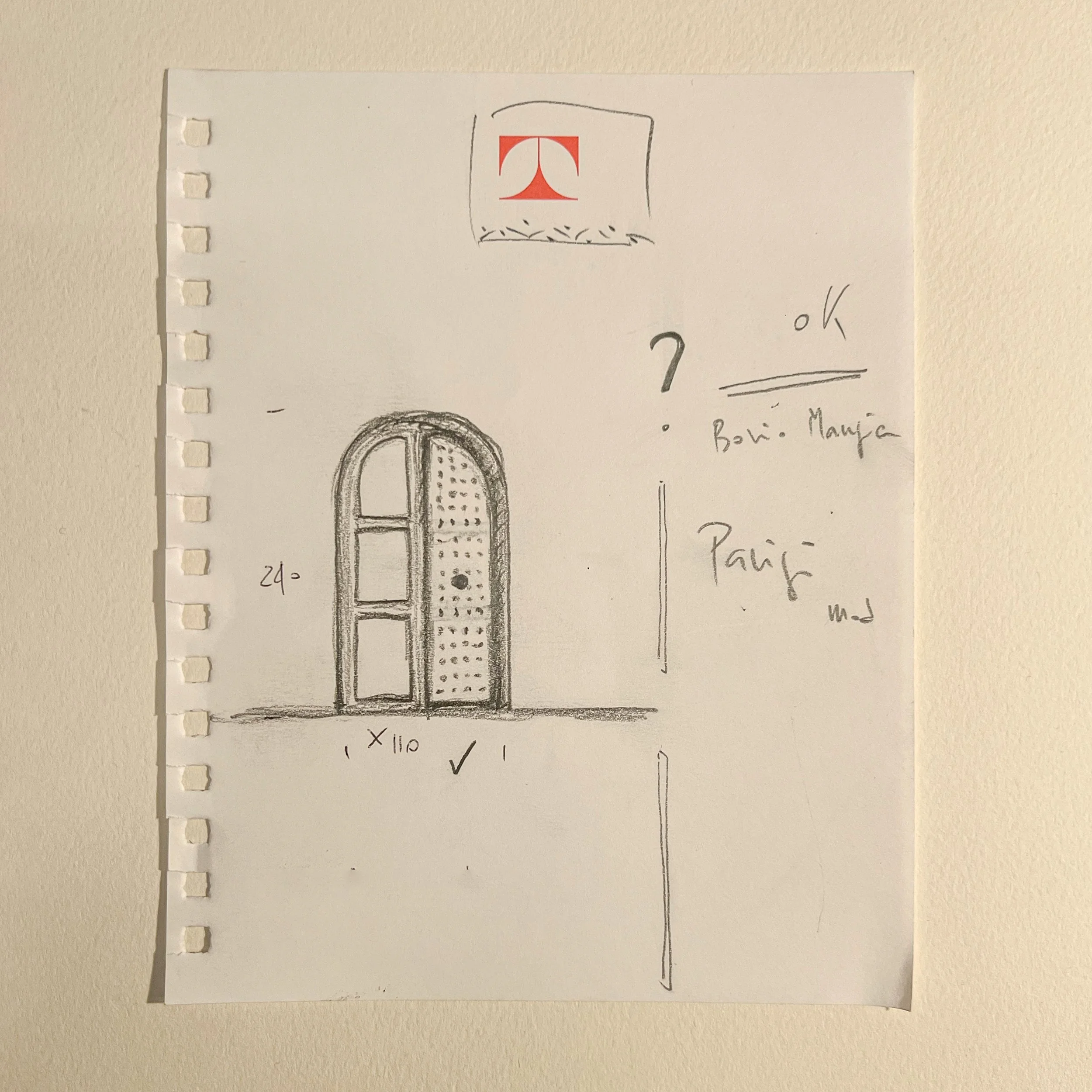 Hand-drawn sketch of an arched door with dimensions, detailed with interior divisions, and notes in discussing sizes and locations, drawn on the Tecno's paper note.