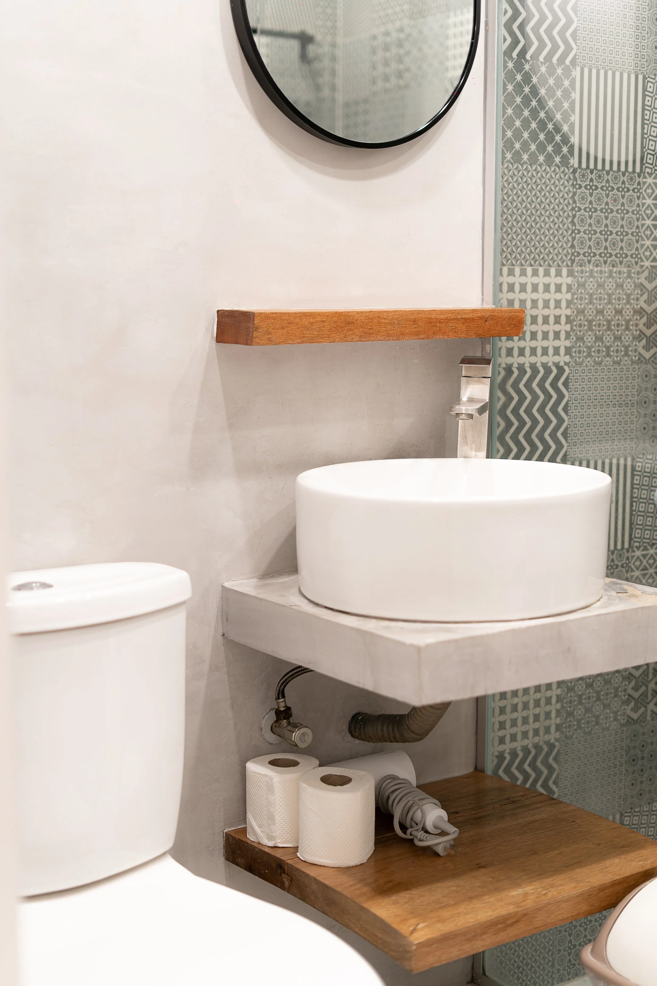White Palm Villas Siargao bathroom with round sink, wooden shelf, and minimalist tropical interior with clean modern finishes