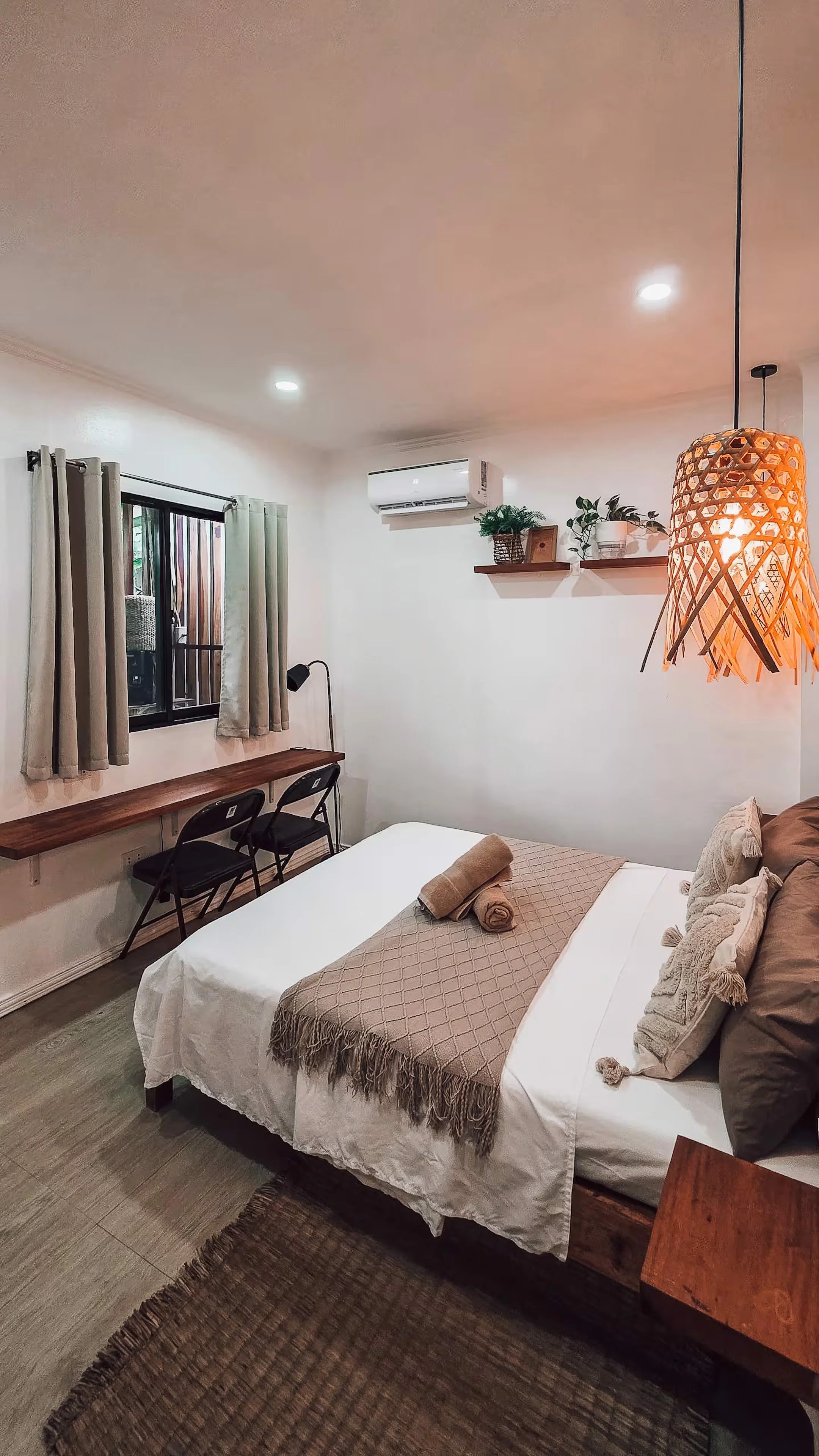 Cozy double bedroom in Surf and Chill Room 3 Siargao with warm lighting and minimalist coastal decor.