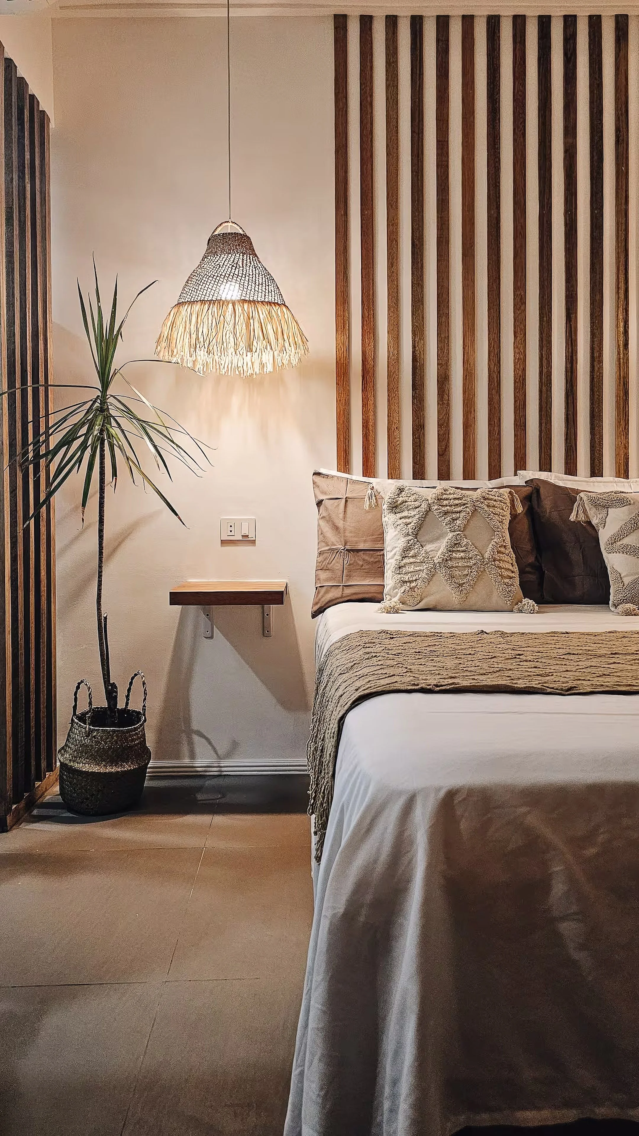 This minimalist corner of Room 2 captures the warmth of natural textures and clean design. A cozy bed, woven lighting, and subtle details make it the perfect Siargao retreat for quiet rest.