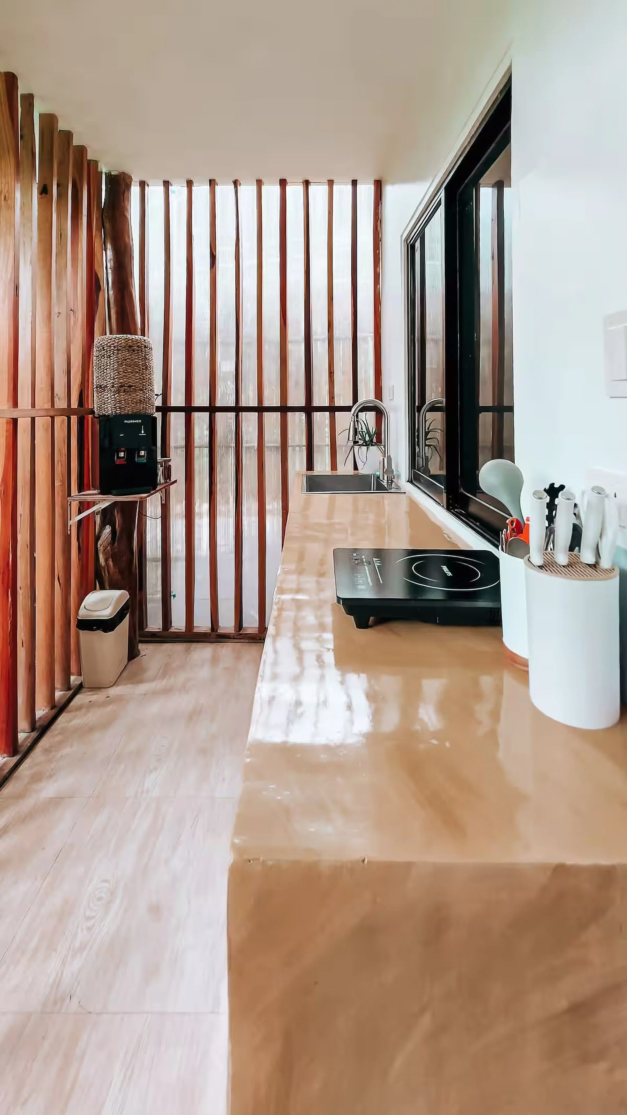 Private outdoor kitchen with sink, induction stove, and utensils inside Surf and Chill Room 3 in Siargao.