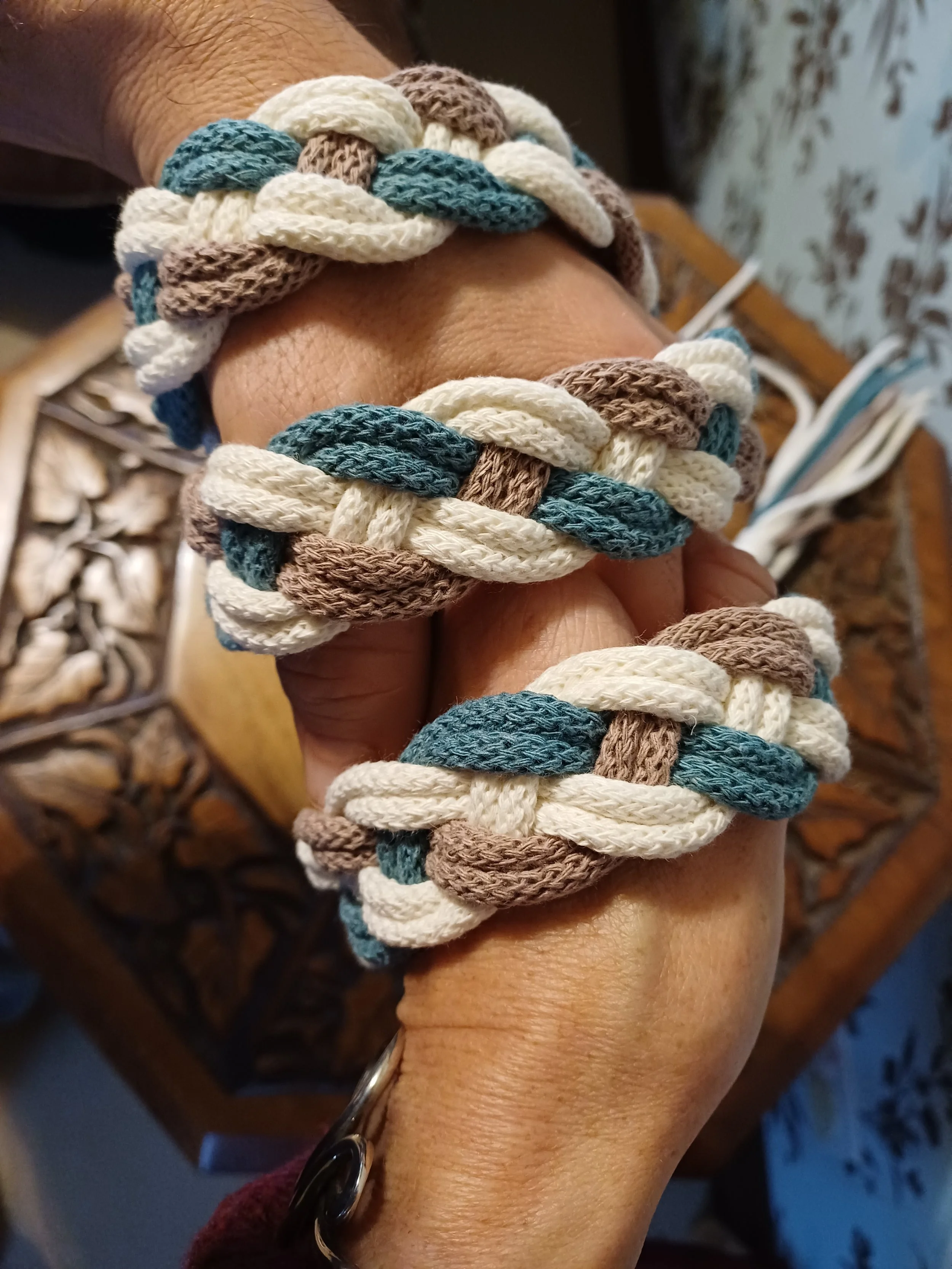 Clasped hands with handfasting cord