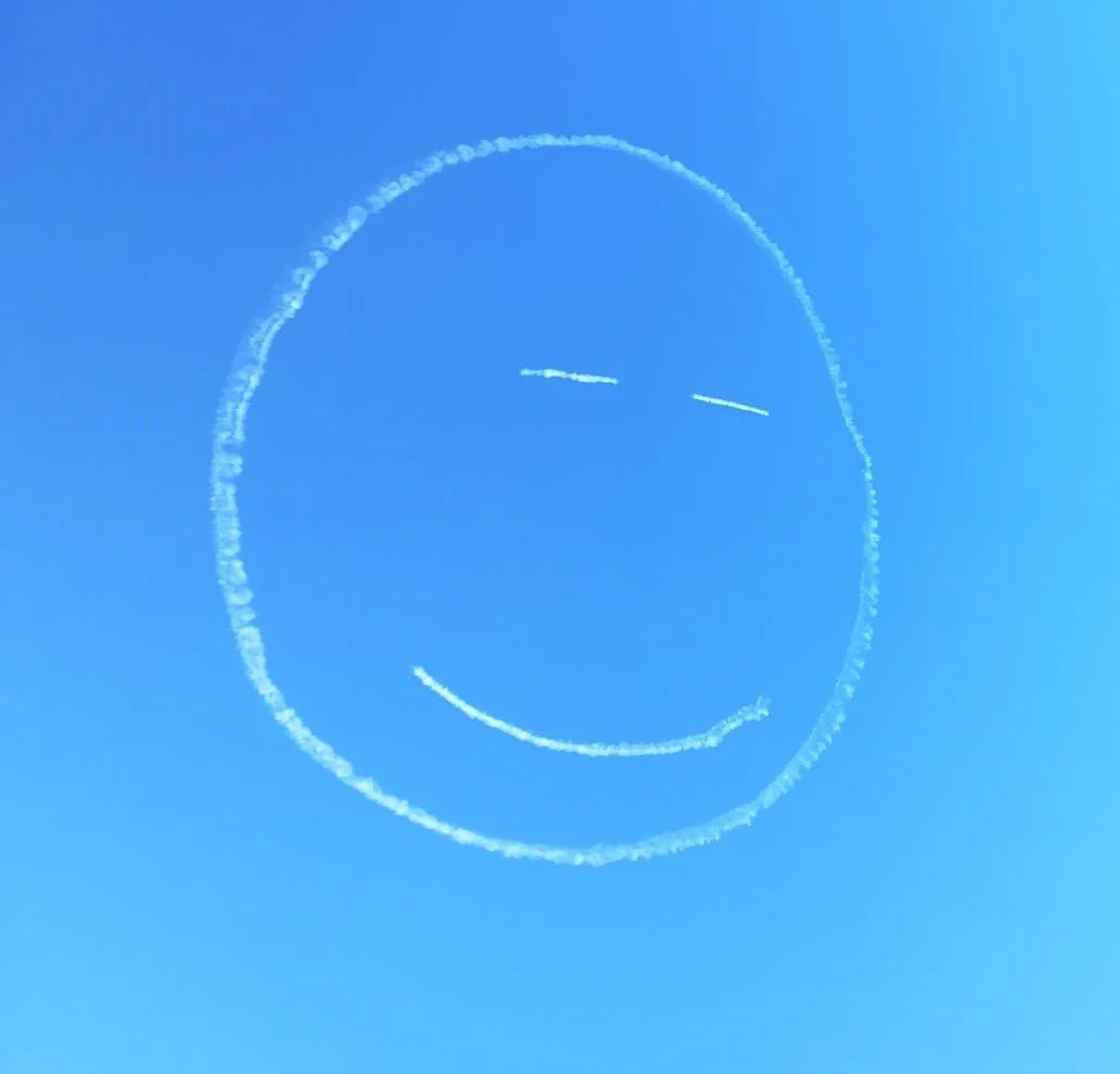 Smiley face made in the sky by a small plane