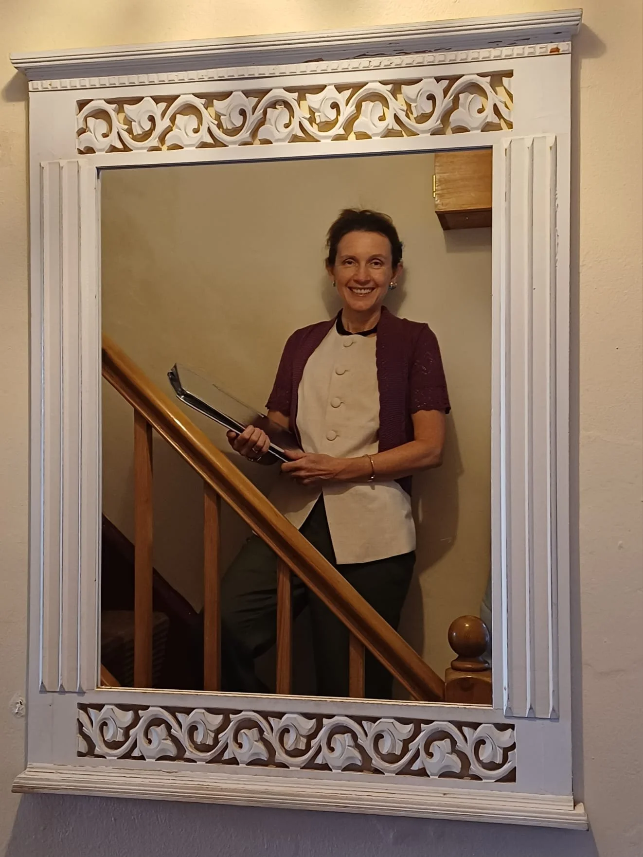 Rachel Peatfield, smiling celebrant - reflected in a mirror