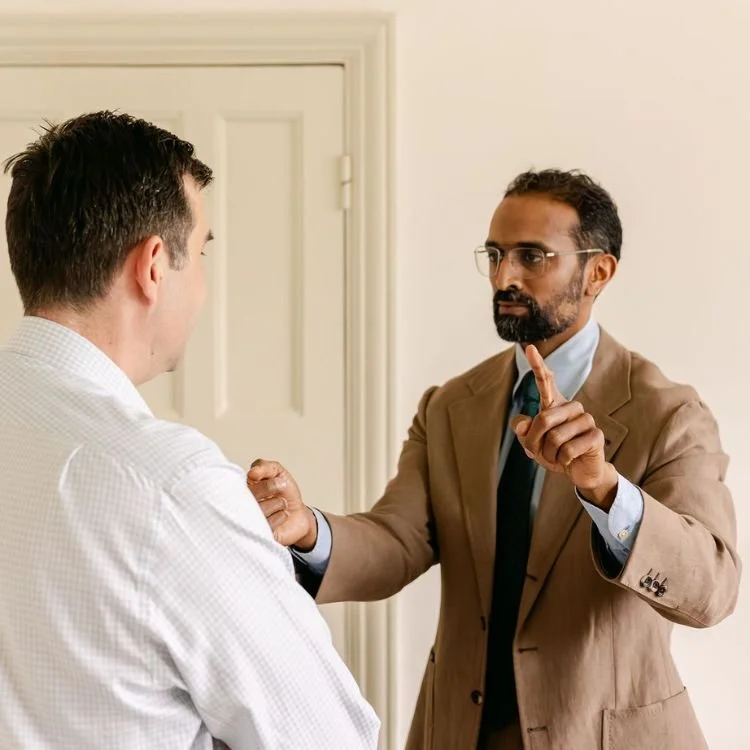 Mr Ahilan Kailaya-Vasan assessing reflexes on patient during private consultation with neurosurgeon