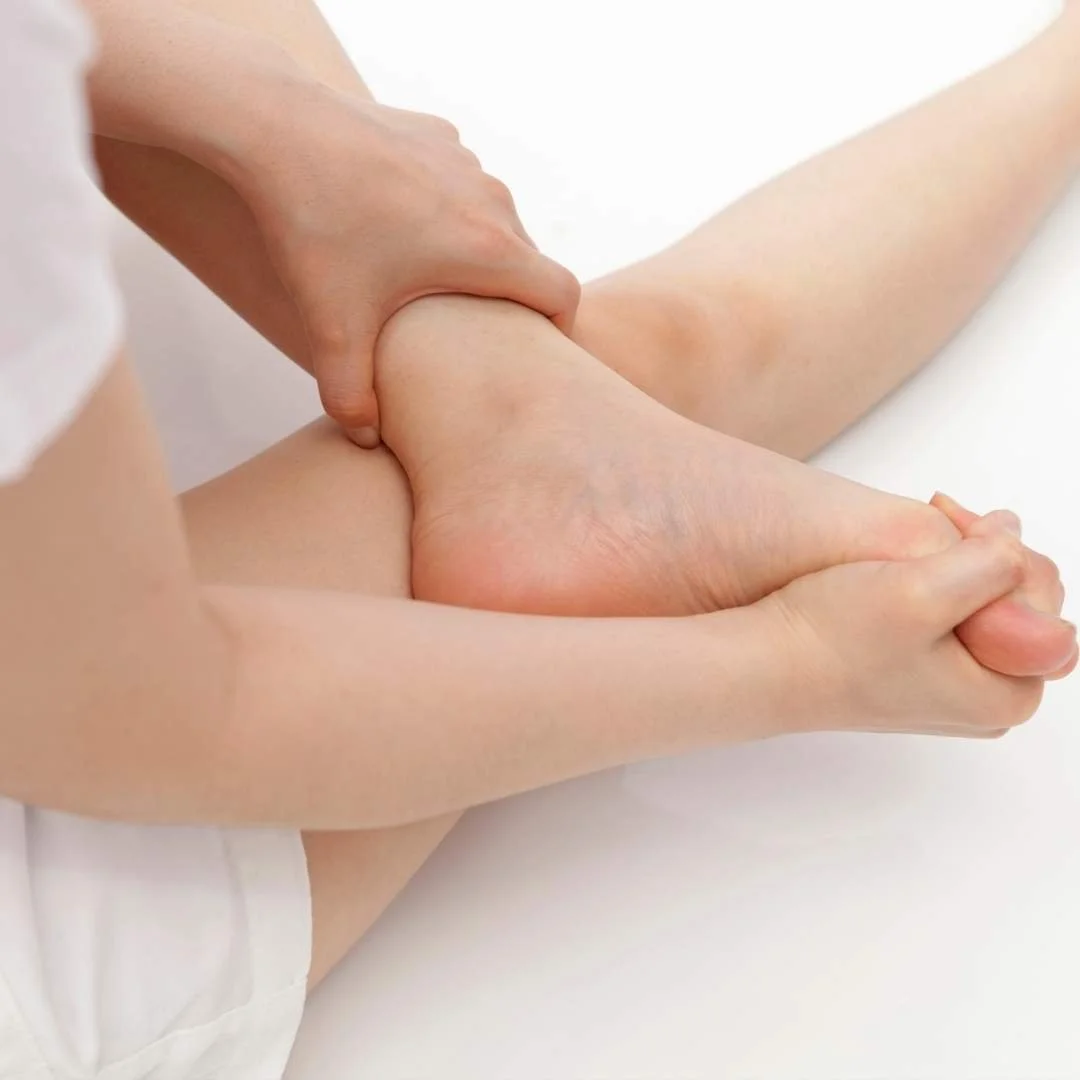 Man touching foot with nerve issues.