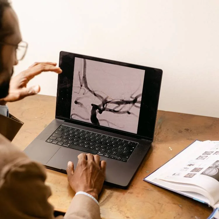 Mr Ahilan Kailaya Vasan, neurovascular surgeon in London, looking at brain aneurysm