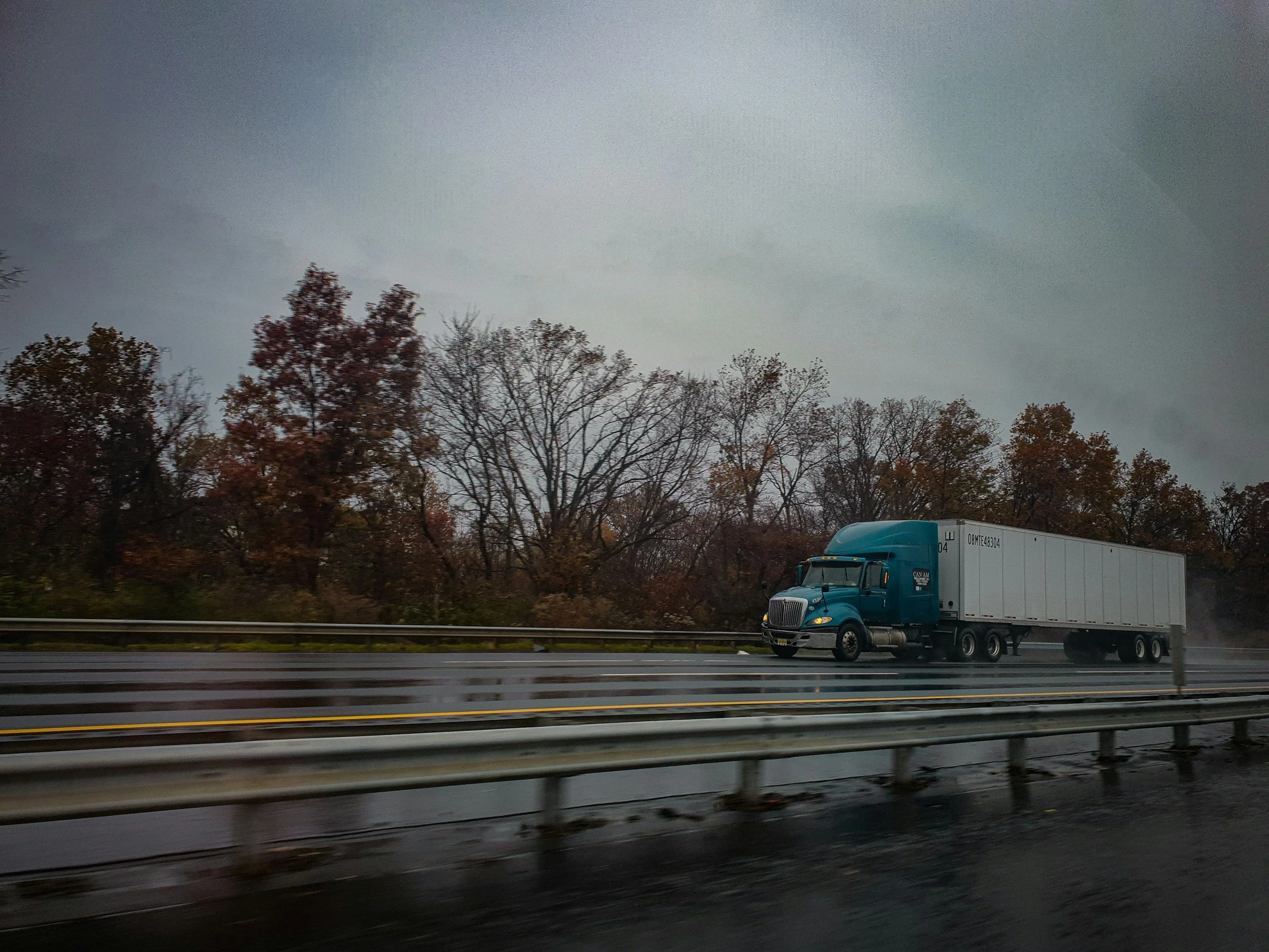 tractor trailer driving on the road in the evening