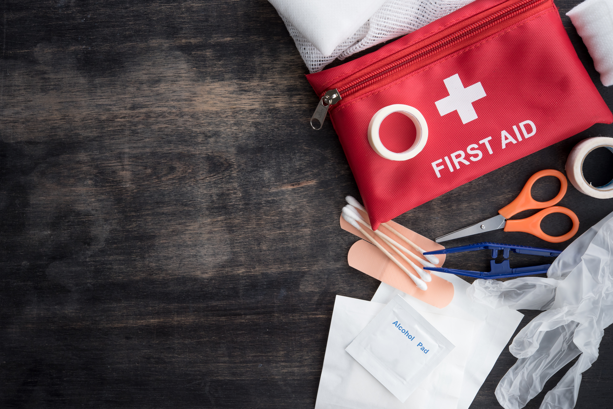 First aid medical kit on wood background