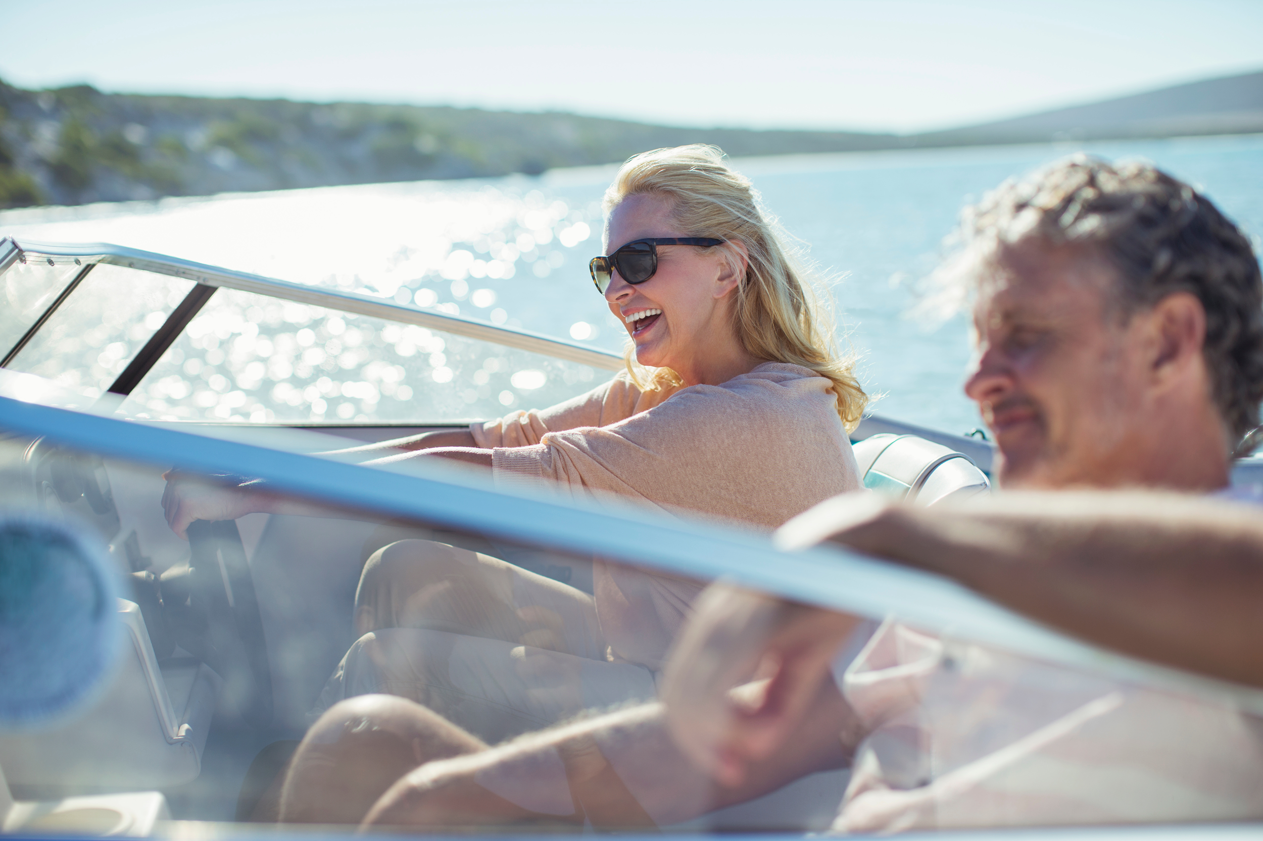 Close up shot of couple driving their boat on lake Ontario