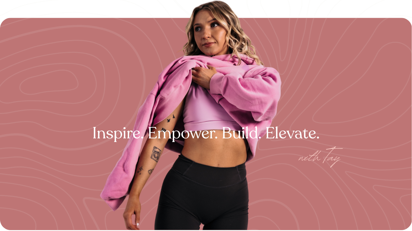 A woman with tattoos on her left arm, wearing a pink cropped top and black leggings, holds a pink hoodie over her shoulder while looking to the side, with a pink background featuring contour lines and motivational text.