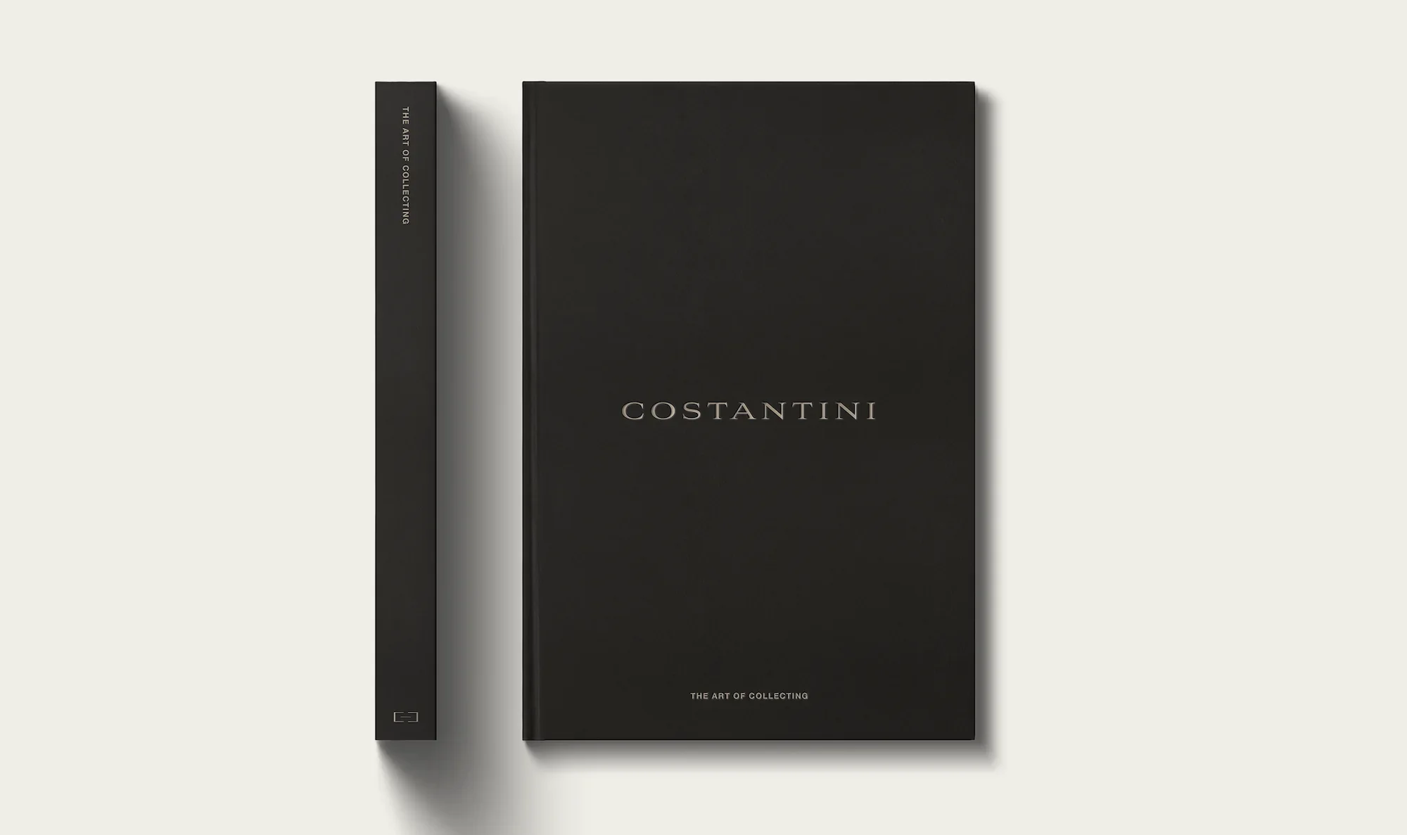 A black book with 'COSTANTINI' on the cover, and a black box of the same design next to it, titled 'THE ART OF COLLECTING'.