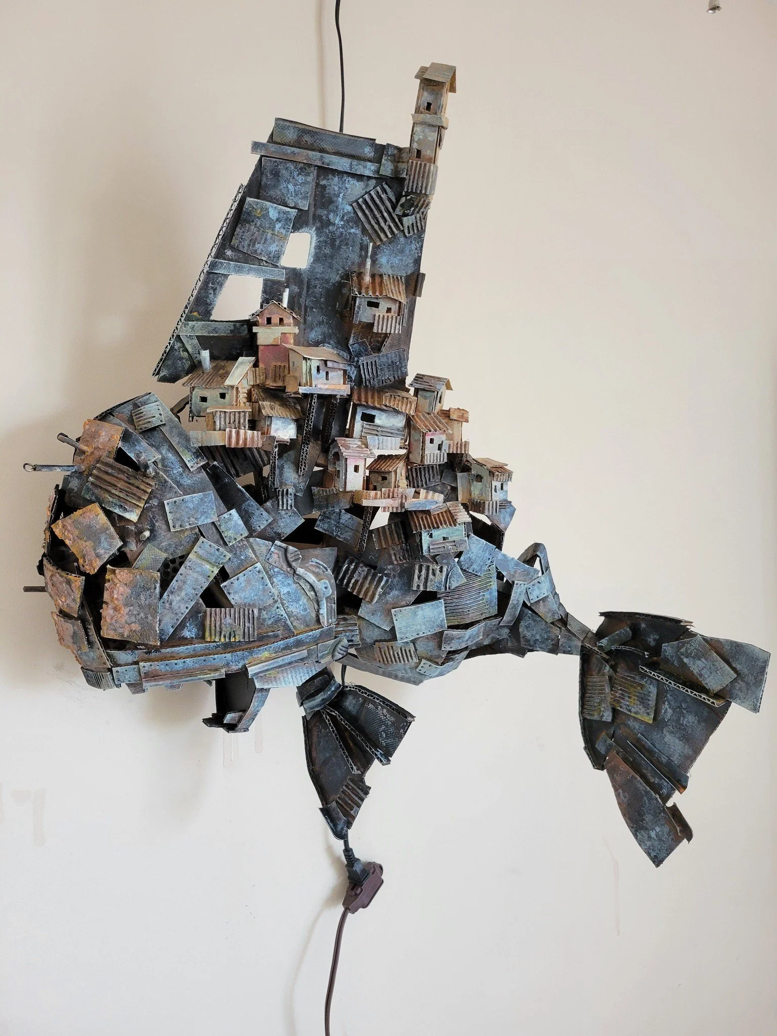 A sculpture of a fish made from cardboard.