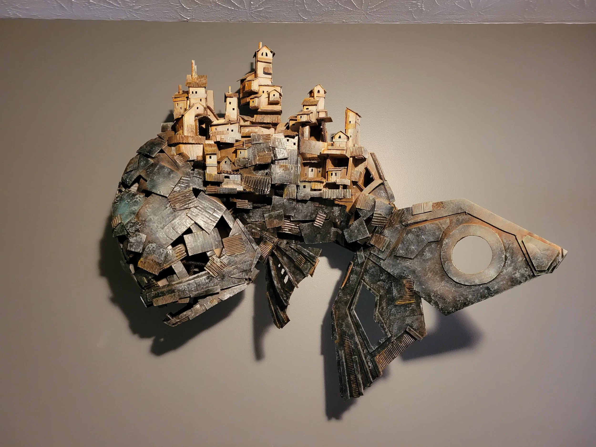 A sculpture of a fish made from cardboard.