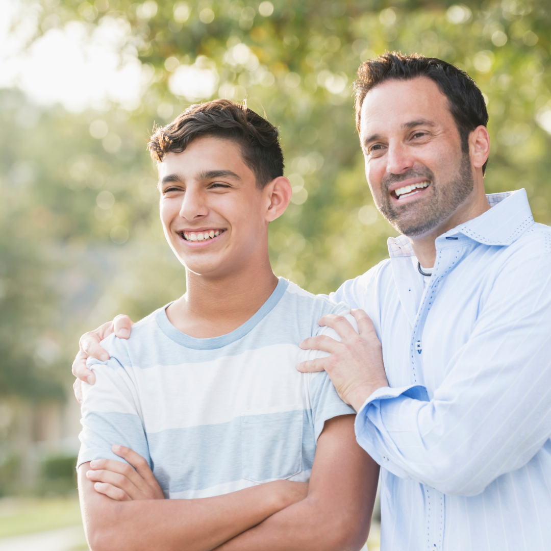 Smiling Dad hugging his son