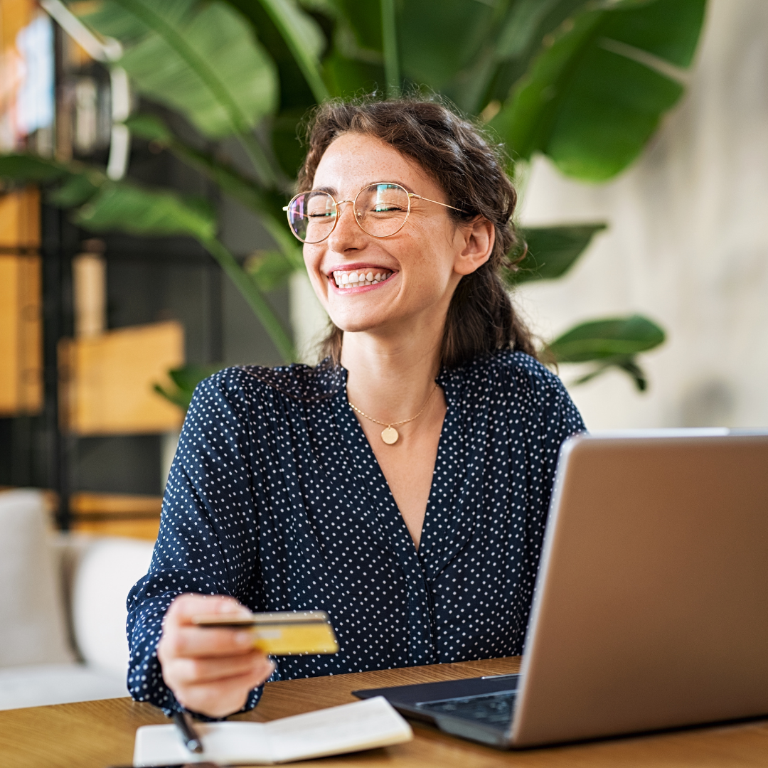 Smiling Woman Holding a Credit Card