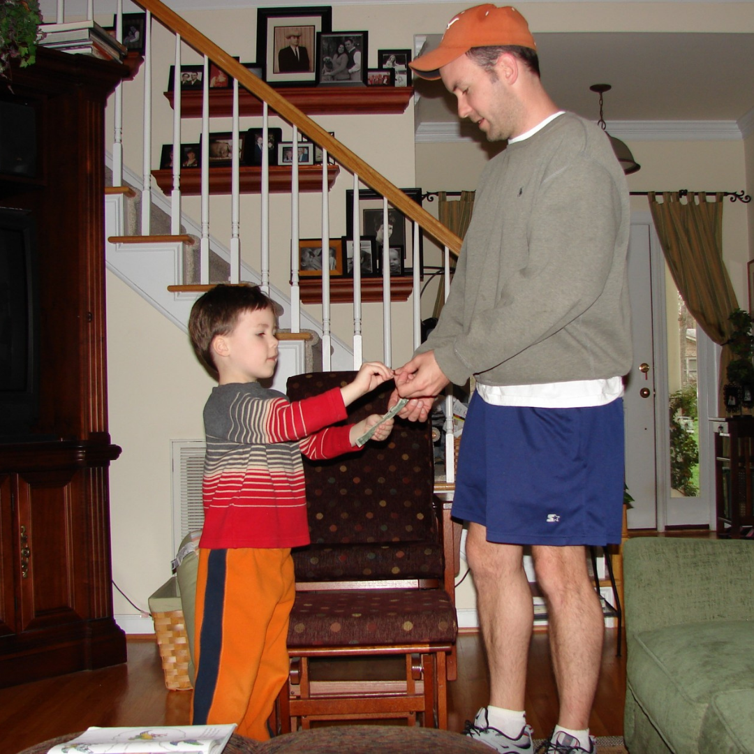 Little boy being handed allowance money