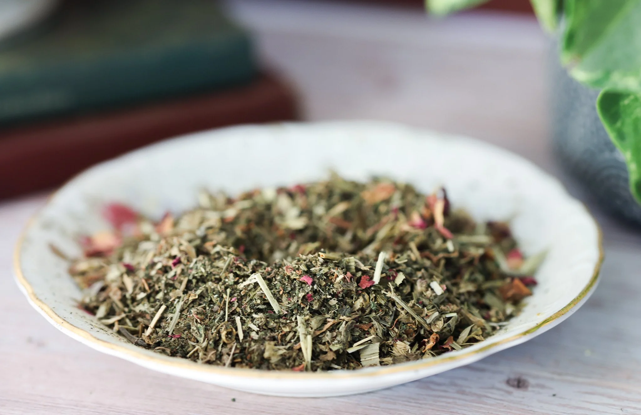 Herbal ovulation support tea with red clover, nettle leaf, oatstraw, damiana, rose petals, and lemon balm in packaging by Raise Wellness.