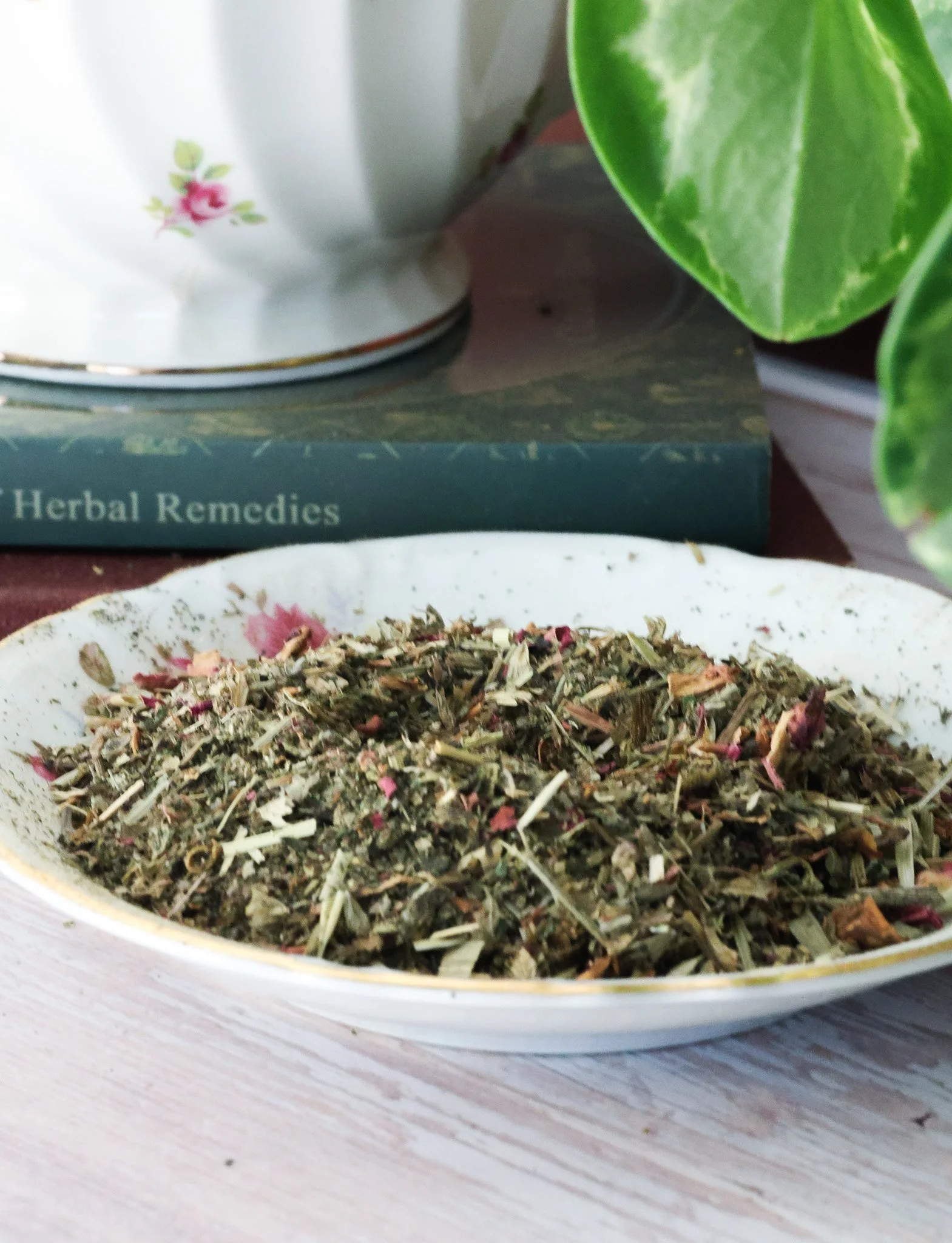 Herbal ovulation support tea with red clover, nettle leaf, oatstraw, damiana, rose petals, and lemon balm in packaging by Raise Wellness.