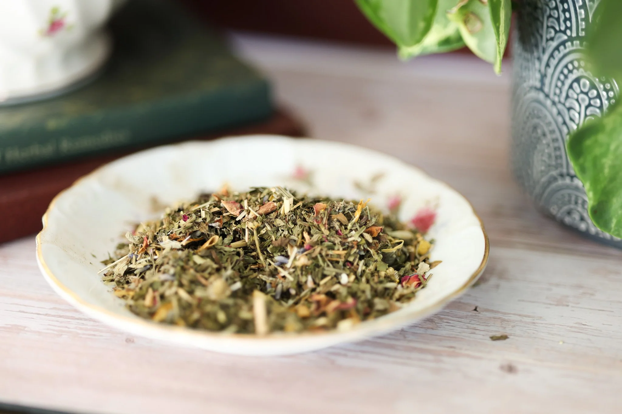 Herbal mood support tea blend with lemon balm, chamomile, rose petals, lavender, and calming botanicals in packaging by Raise Wellness.