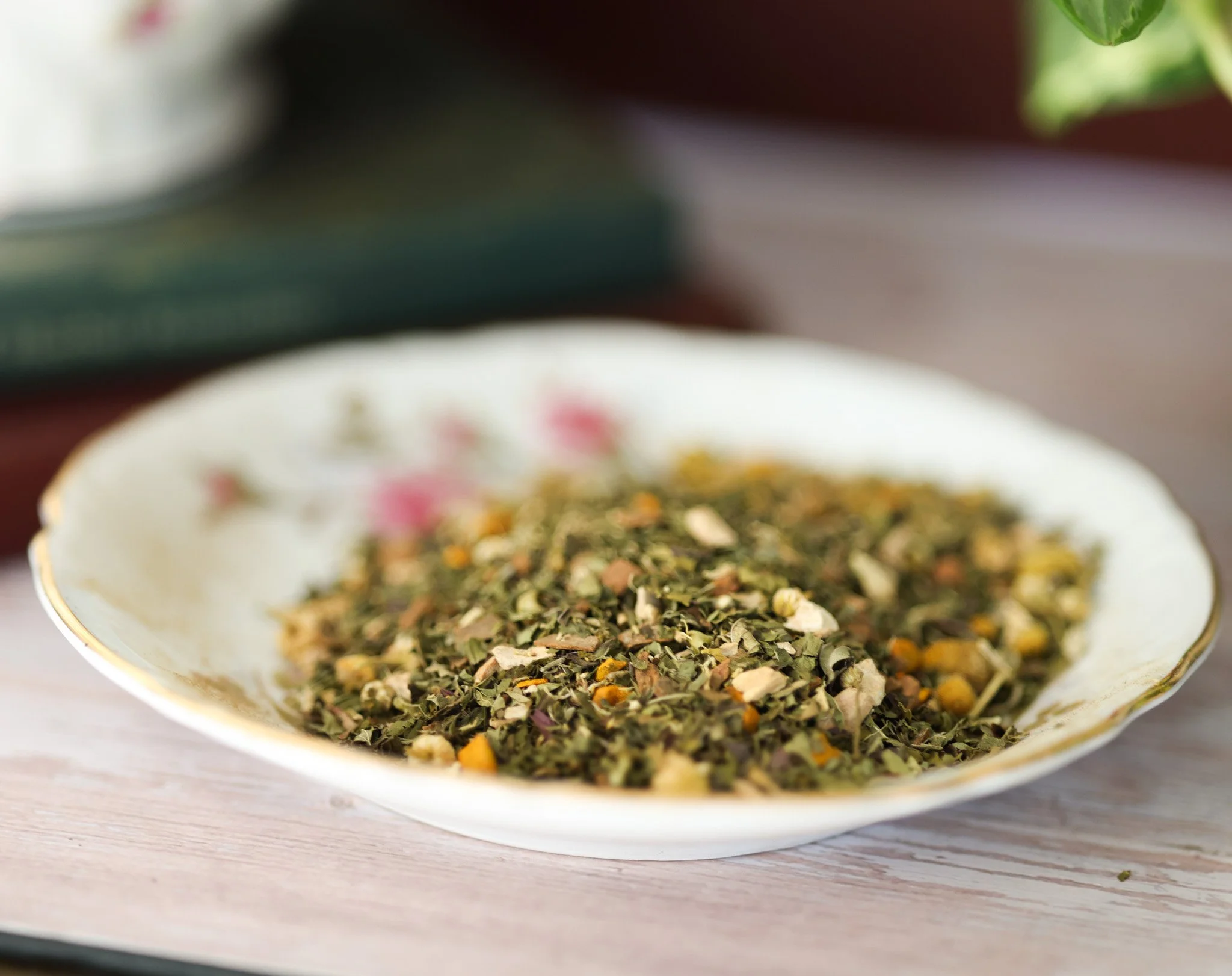 Herbal pain support tea blend with skullcap, St. John's wort, chamomile, turmeric root, ginger root, licorice root, cinnamon chips, and peppermint in packaging by Raise Wellness.