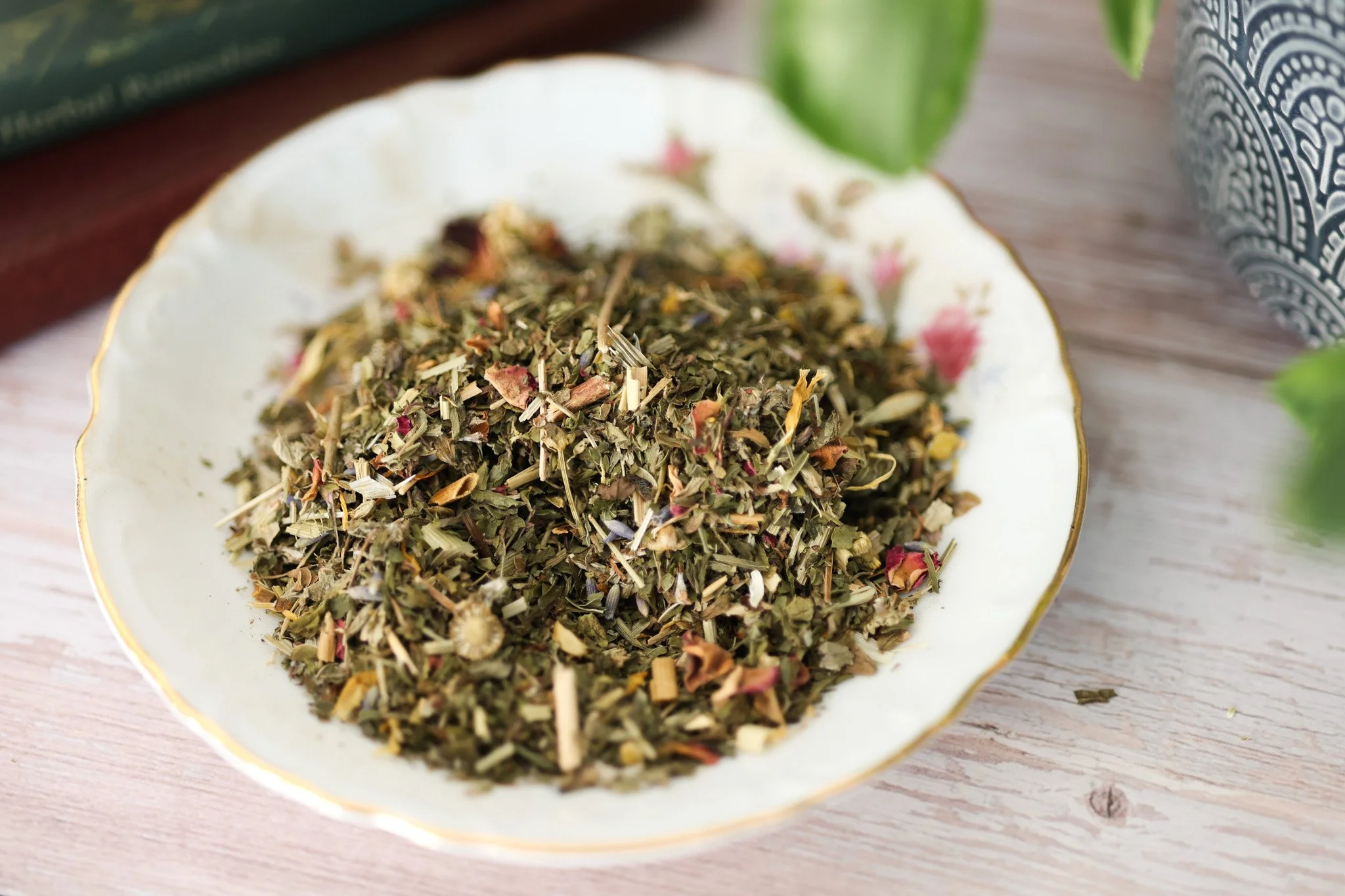 Herbal mood support tea blend with lemon balm, chamomile, rose petals, lavender, and calming botanicals in packaging by Raise Wellness.