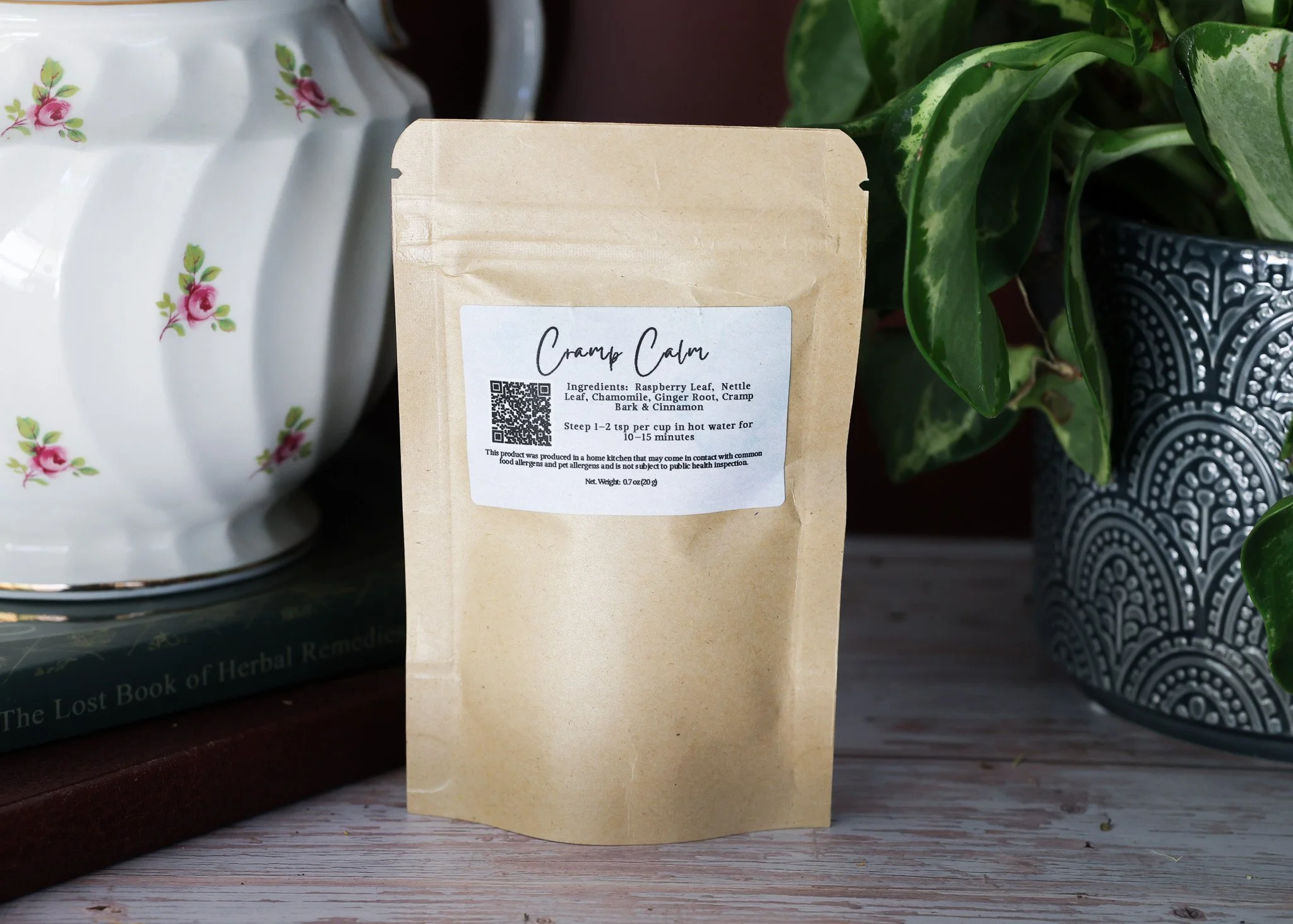 Herbal menstrual support tea with raspberry leaf, nettle, chamomile, ginger root, cramp bark, and cinnamon in packaging by Raise Wellness.