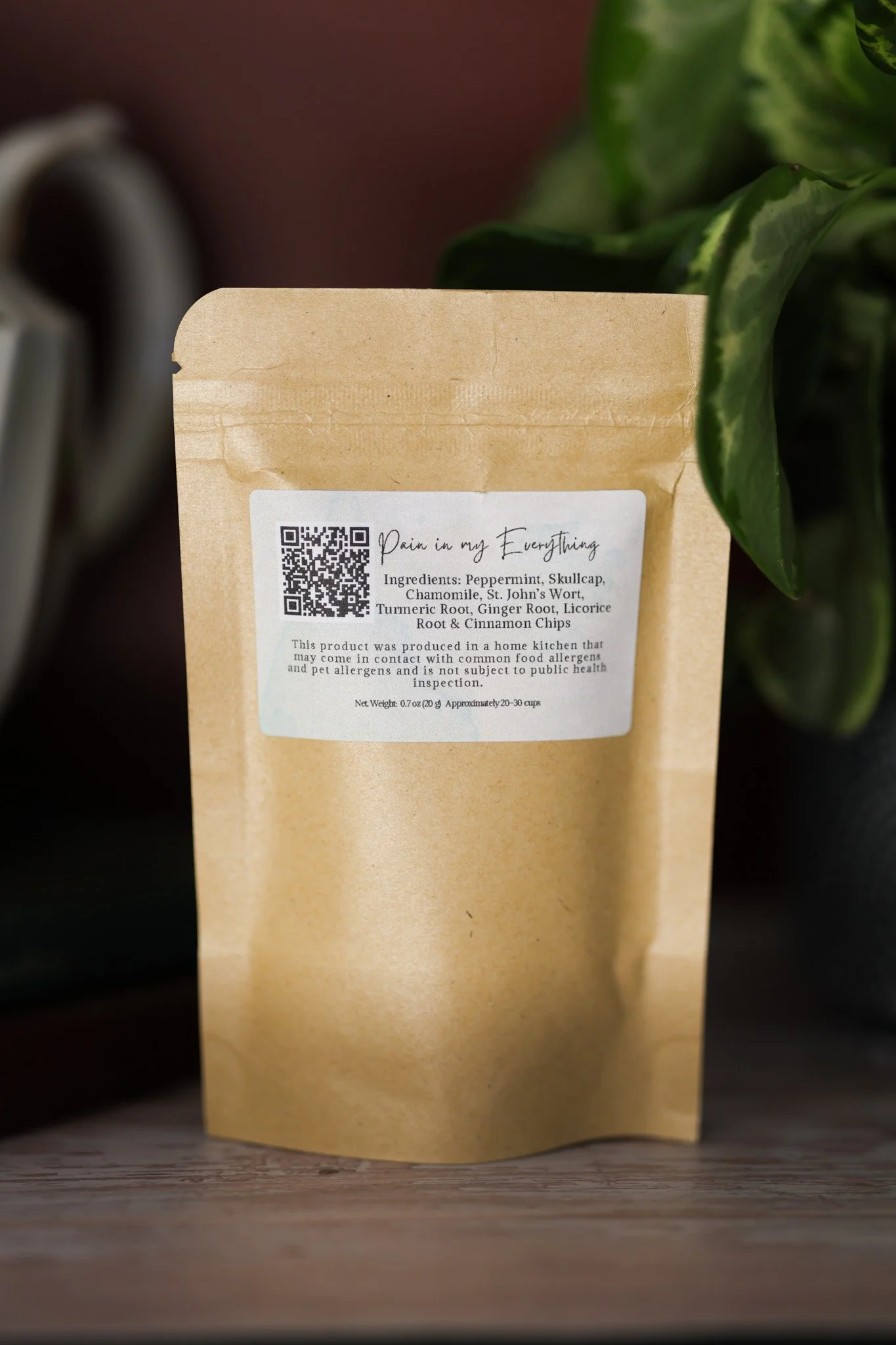 Herbal pain support tea blend with skullcap, St. John's wort, chamomile, turmeric root, ginger root, licorice root, cinnamon chips, and peppermint in packaging by Raise Wellness.