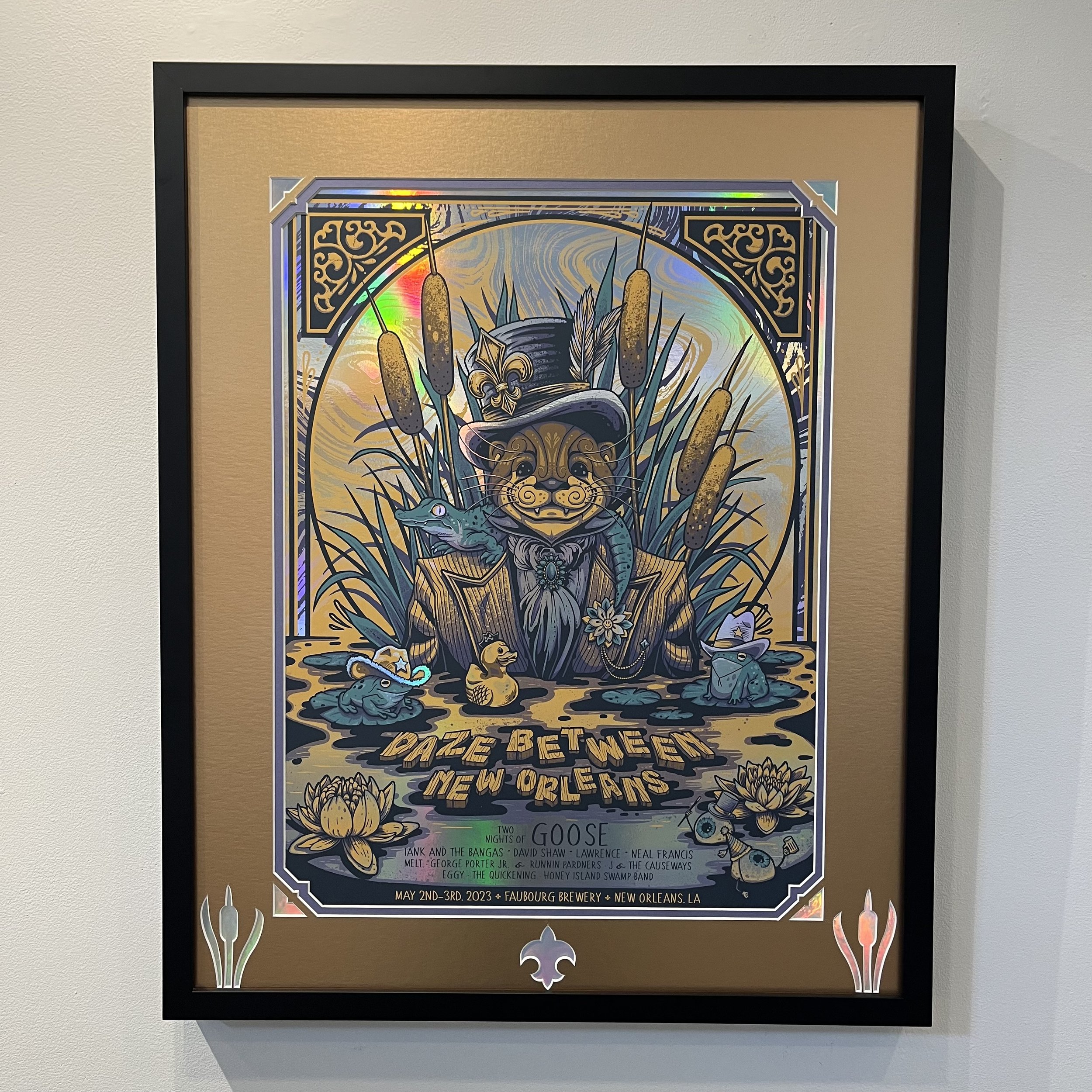 Colorful poster titled "Daze Between New Orleans" featuring a central image of a lion wearing a hat, surrounded by a crocodile, a duck, frogs, and lily pads, with cattails and decorative borders, advertising a music event at Faubourg Brewery in New O