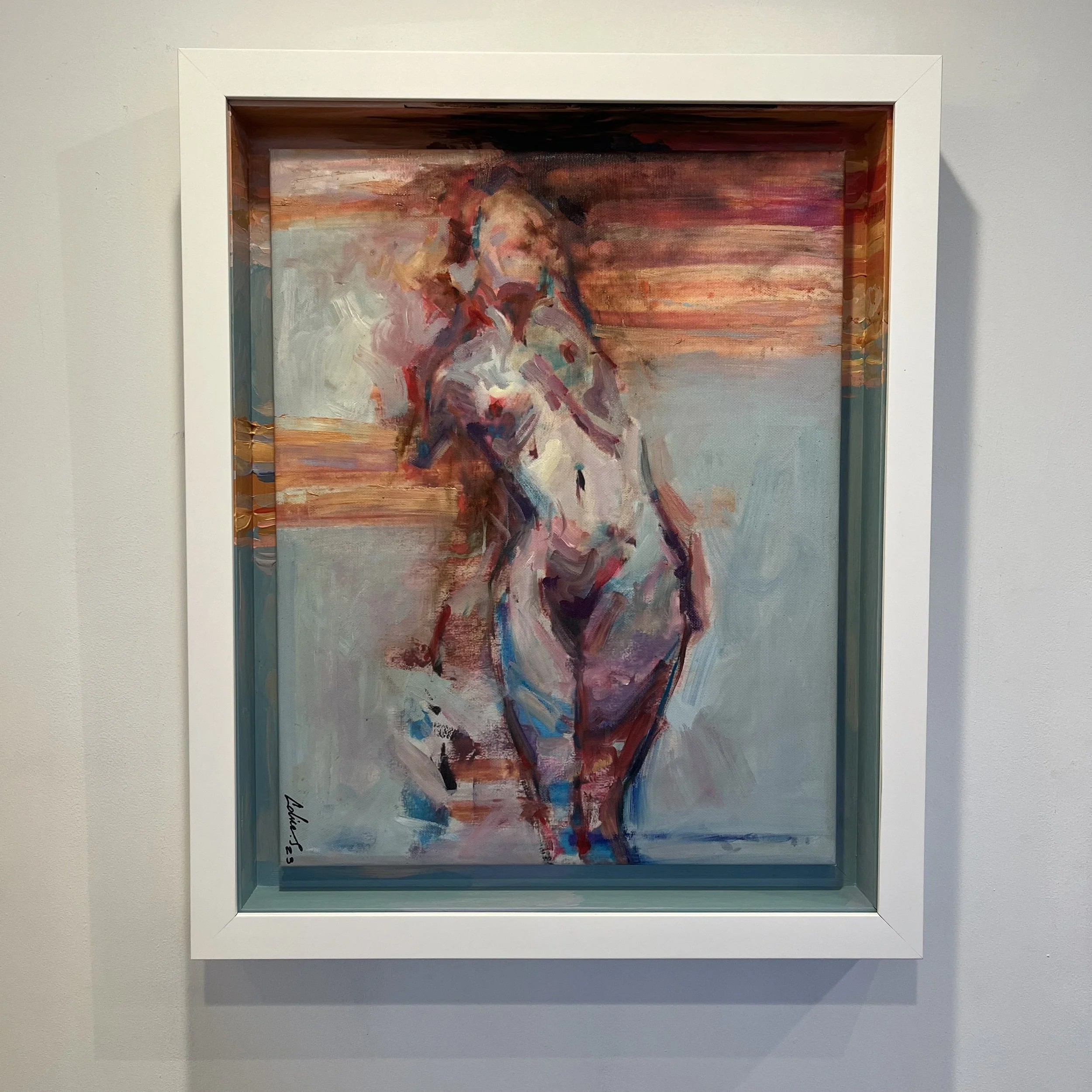 Abstract painting of a nude female figure with a background of warm and cool colors, framed in white.