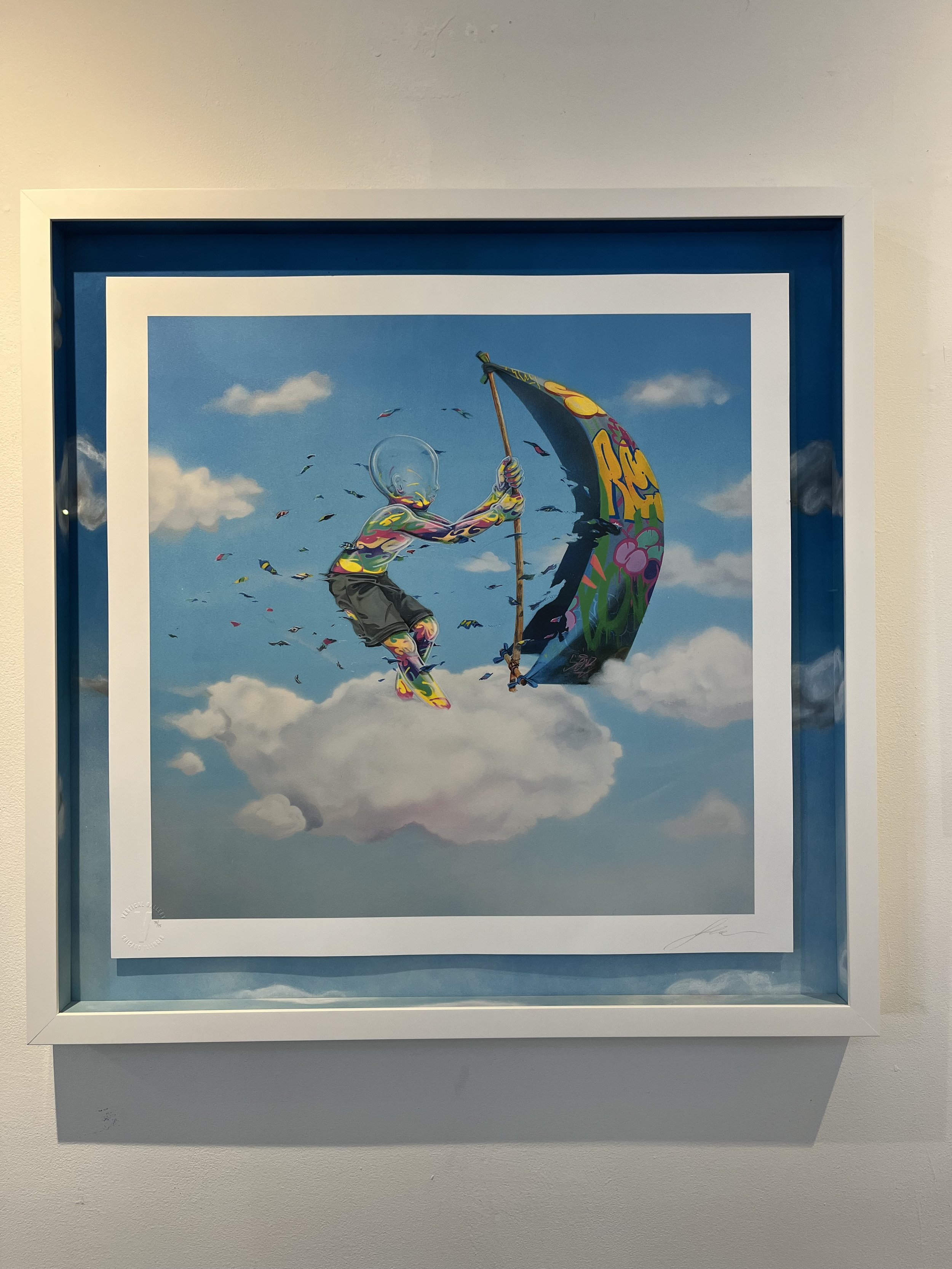 A colorful painting of a figure with a humanoid body and a clear, glass-like head, kite surfing on clouds with a graffiti-covered kite under a blue sky.