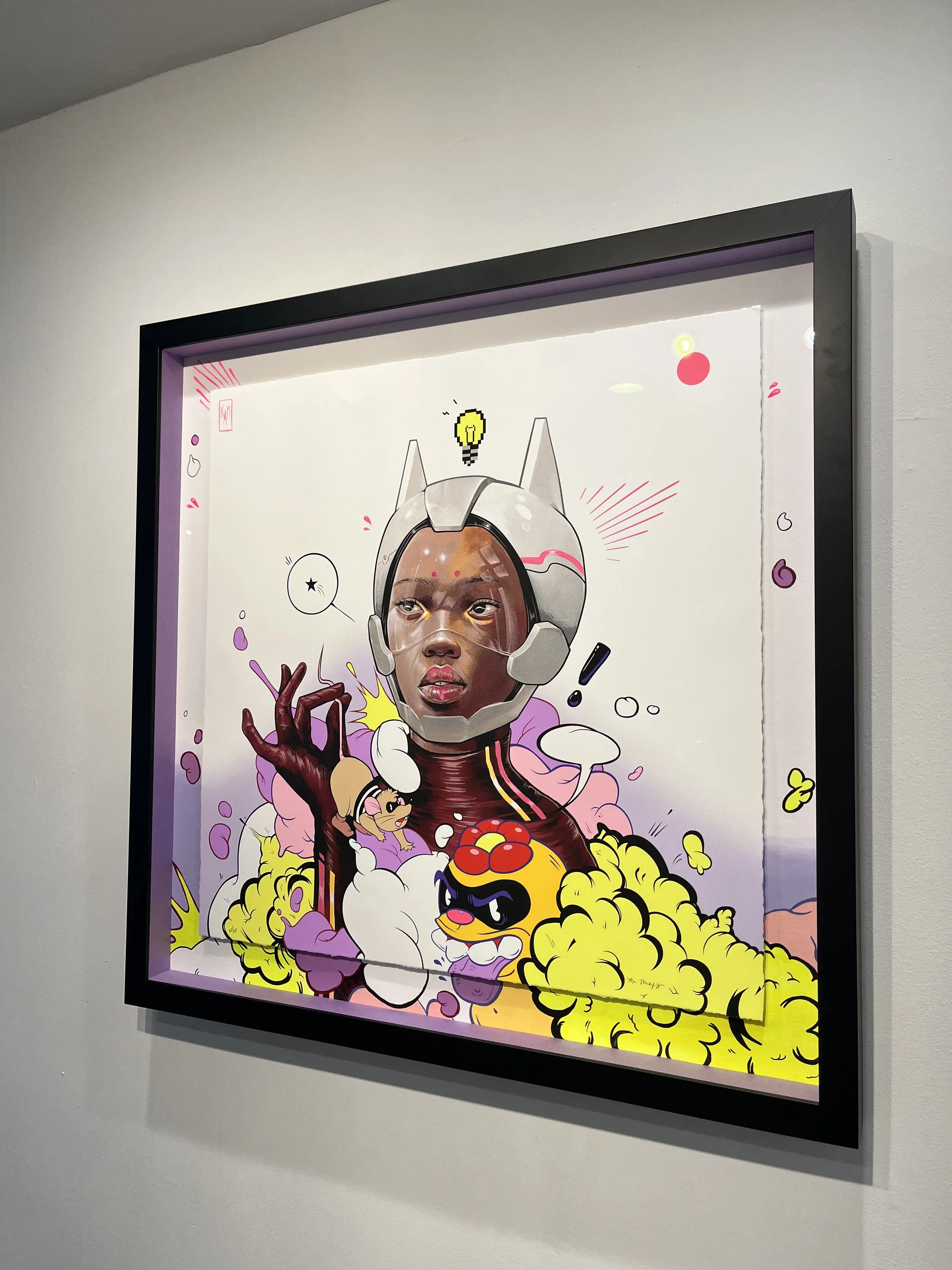 A framed piece of modern pop art depicting a female figure with a robot cat helmet and a human face, surrounded by colorful cartoonish characters, clouds, and playful elements, in a vibrant, comic style.