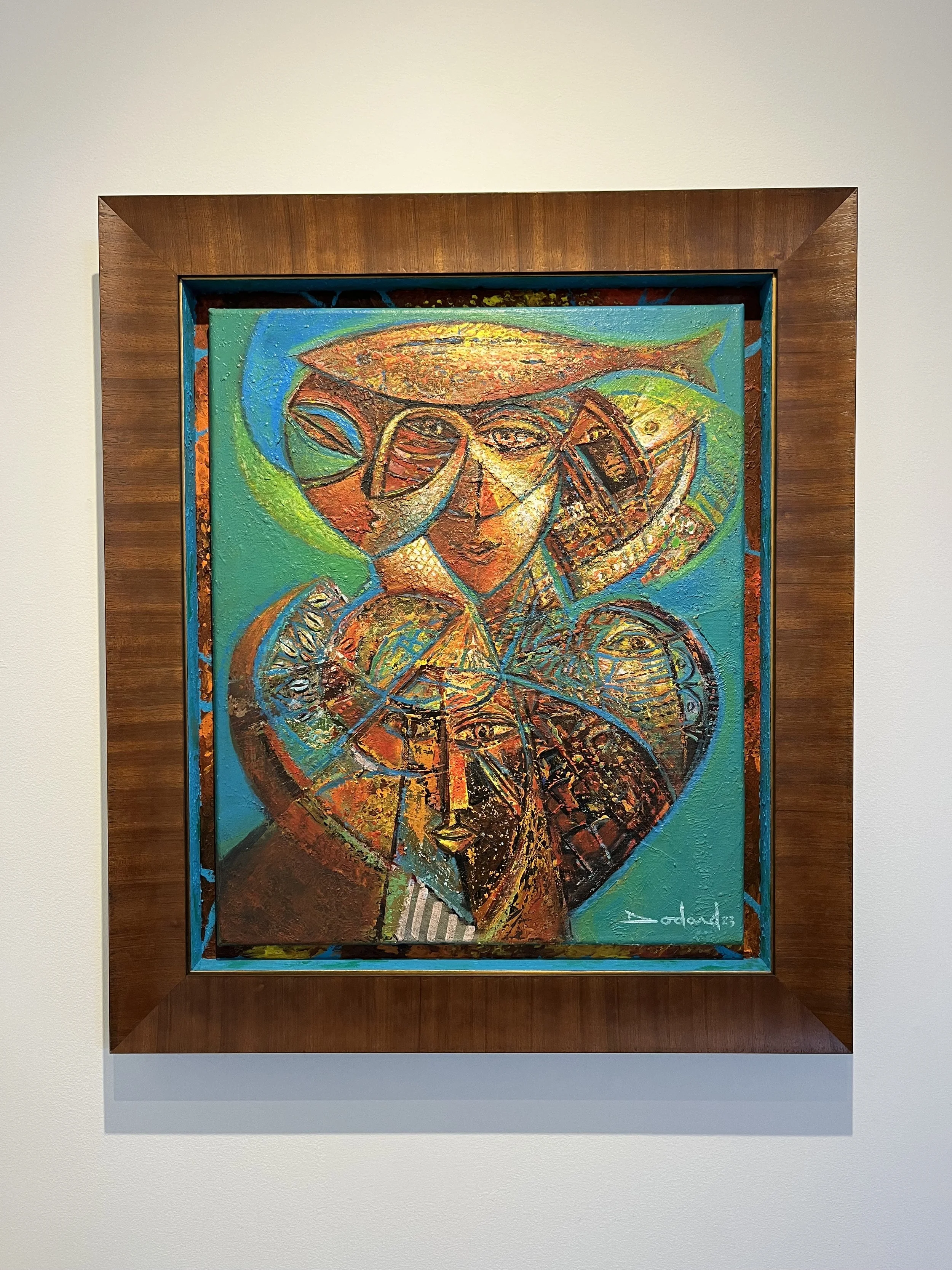 Colorful abstract painting of faces with geometric shapes, framed in wood, signed by the artist, Pedro Valada in 2023.