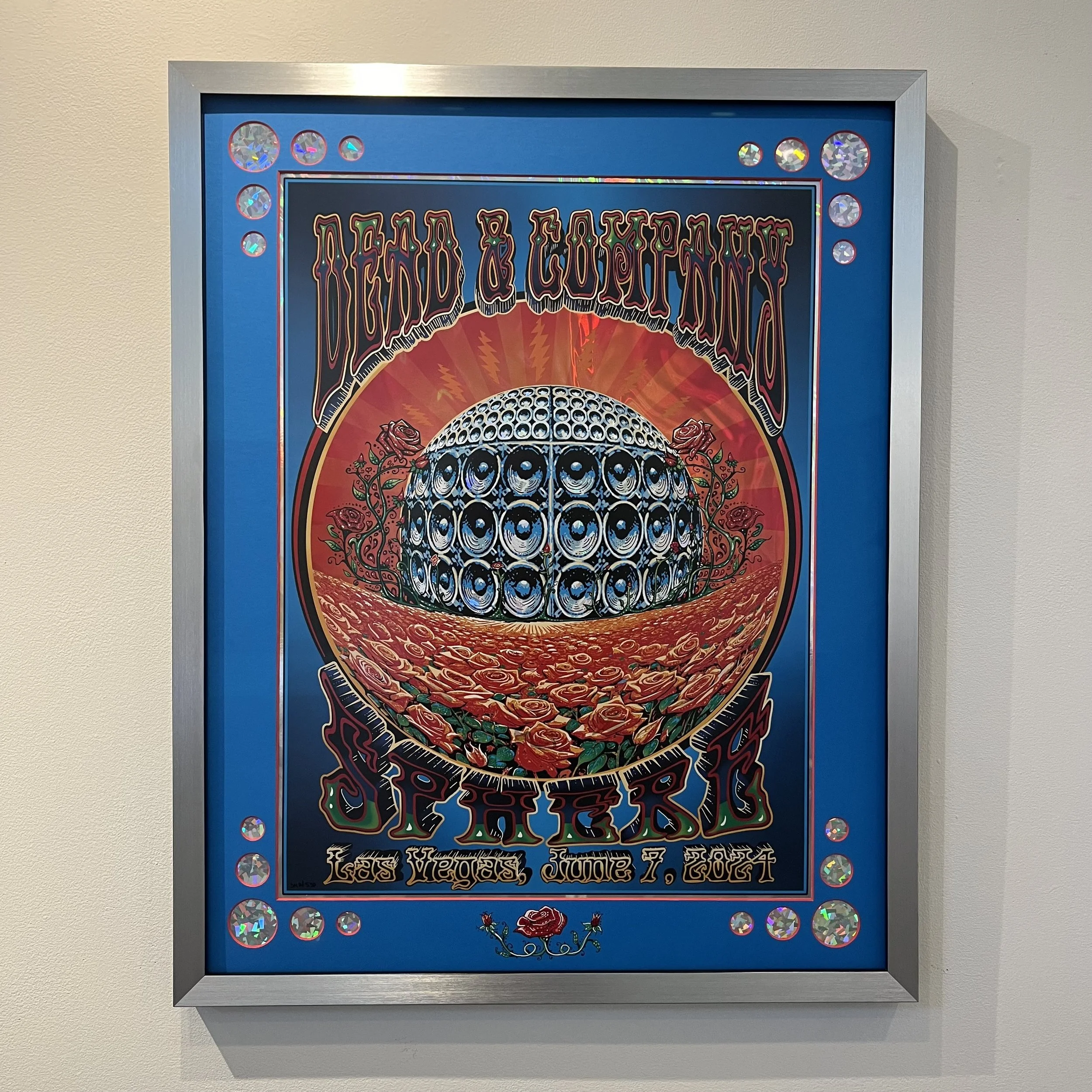 Colorful poster for Dead & Company summer tour in Las Vegas, June 7, 2017, featuring a psychedelic design with a spherical structure made of speakers, roses, and bold, ornate text.