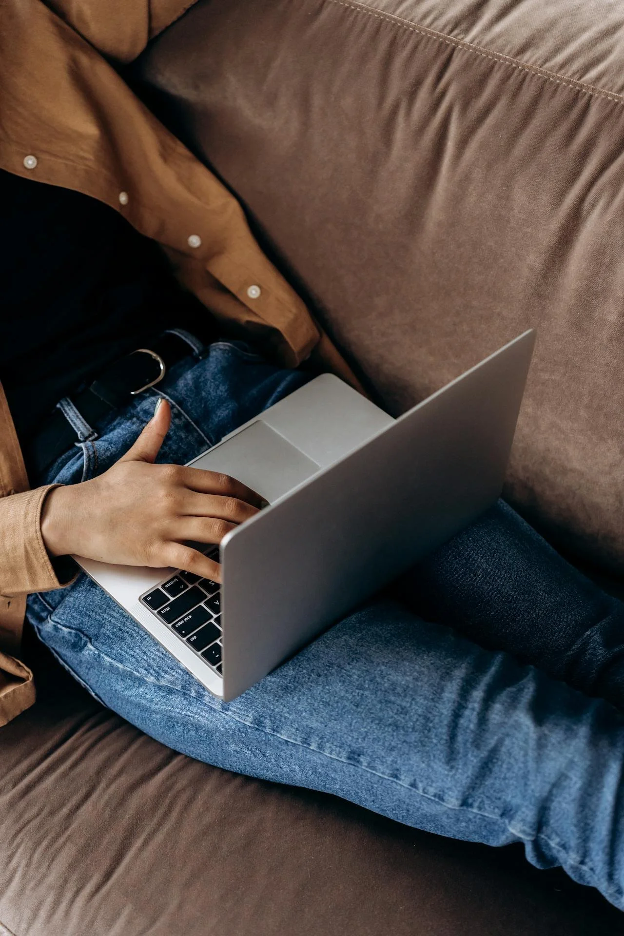 woman using laptop on couch