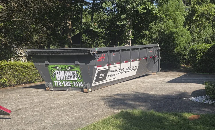 20 yard roll-off dumpster in a residential driveway