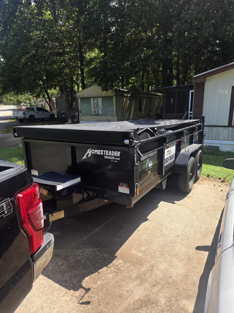 7 yard dump trailer positioned in a tight residential driveway