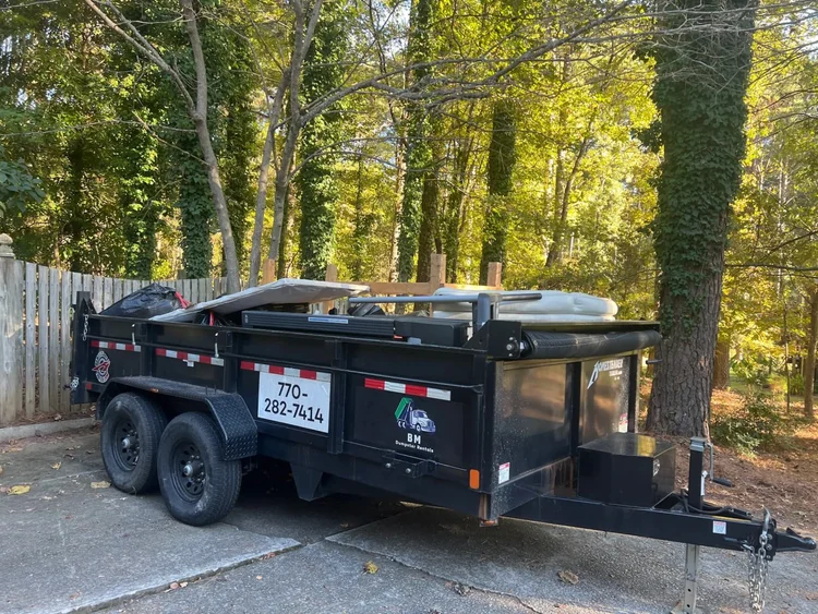 BM Dumpster Rentals 7 yard dump trailer in a residential driveway in Fayetteville Georgia