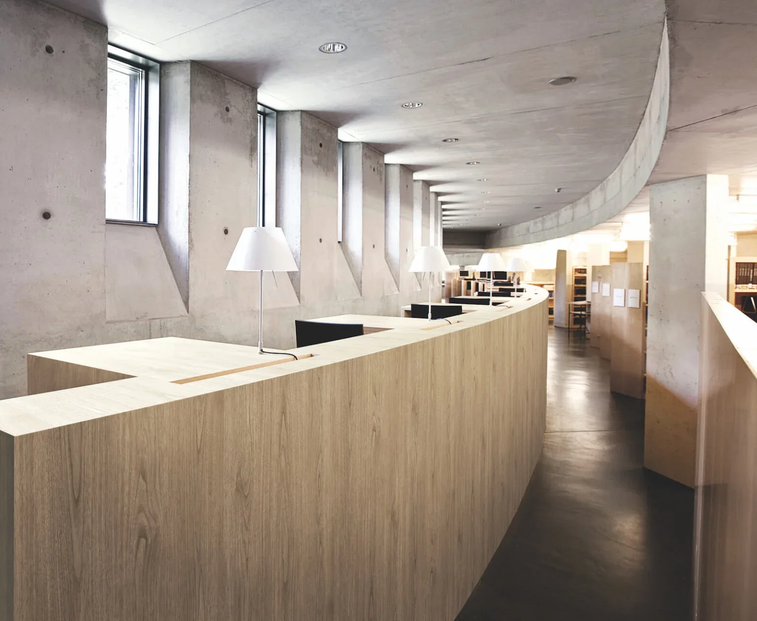 Image shows a long desk that has been covered in a light wood.