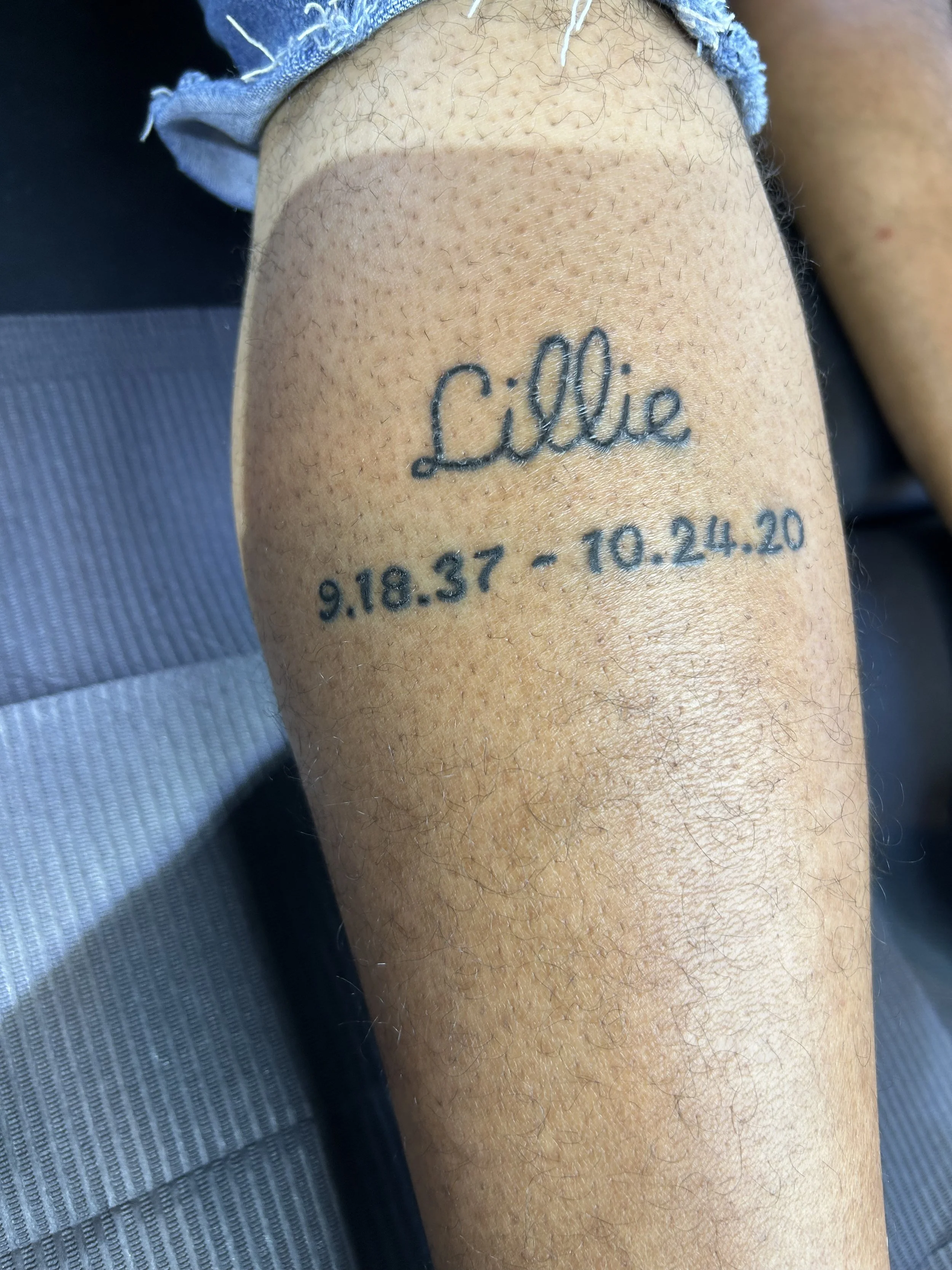 Tattoo on a person's arm with the name 'Lillie' and birth and death dates: September 18, 1937 and October 24, 2020.